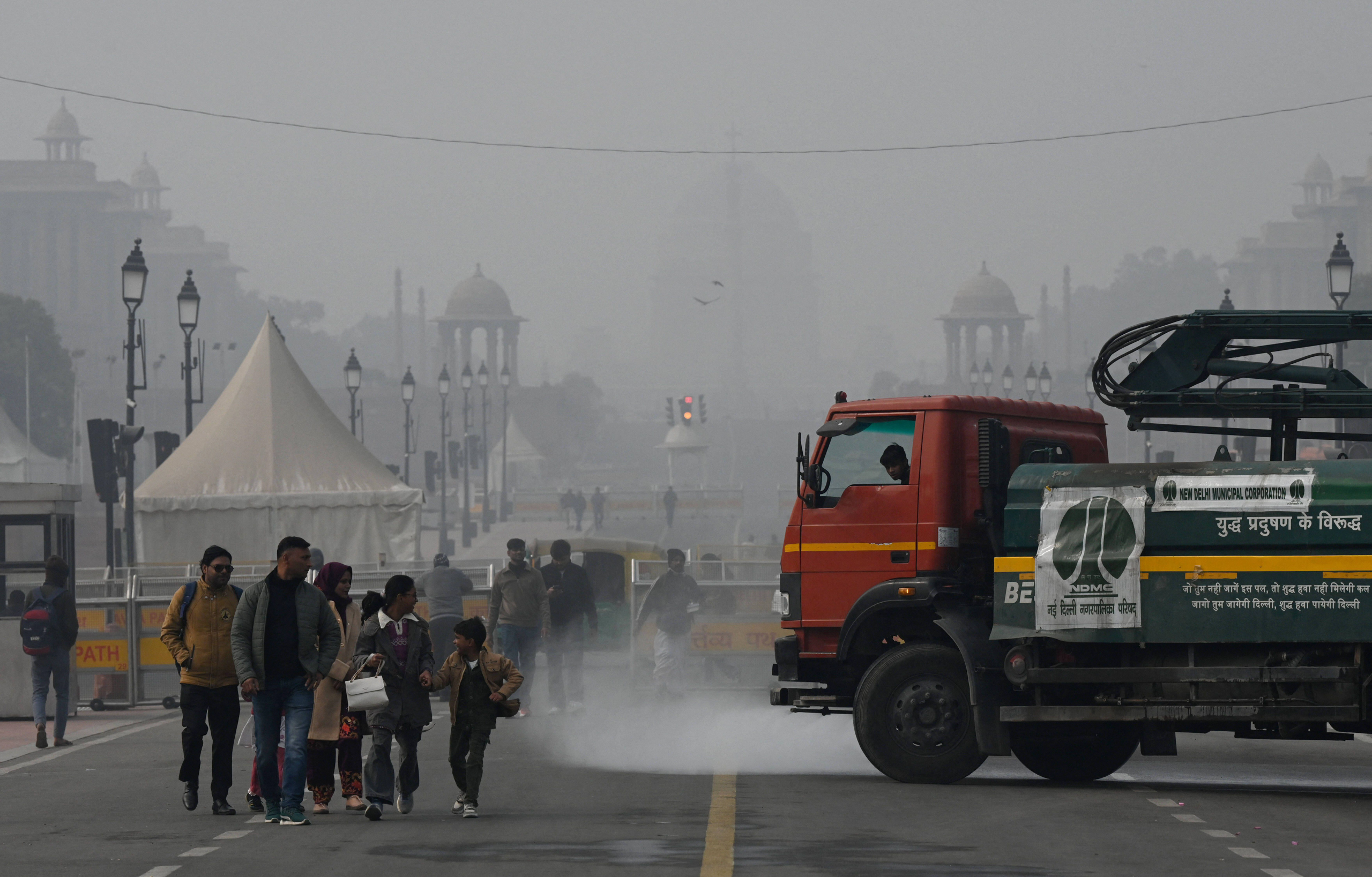 truck spraying water onto path