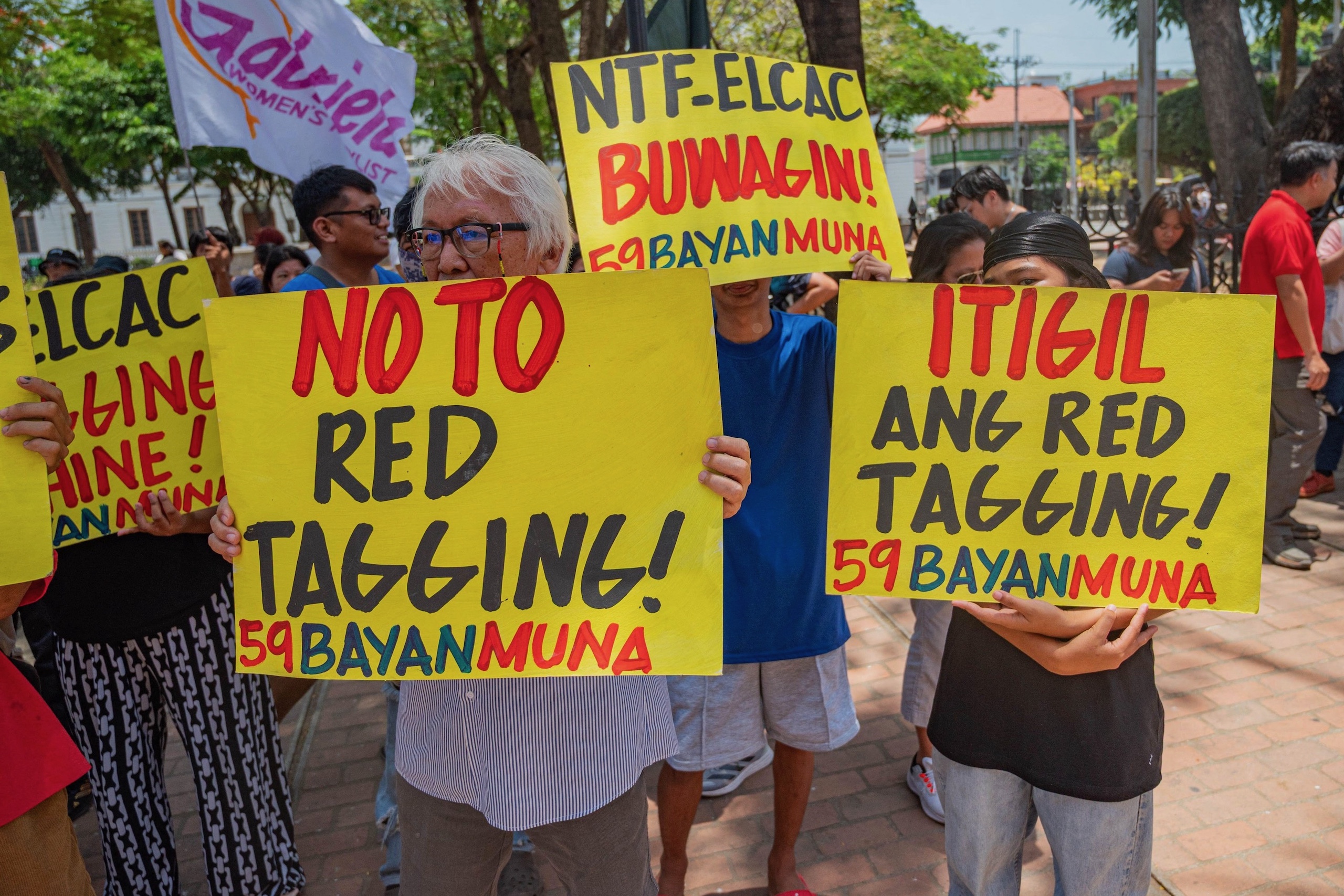 <p>Protestors in Quezon City hold up signs against red-tagging, a practice in which individuals and groups involved in community projects are accused of having links with communism or terrorism (Image: Kenosis Yap / ZUMA Press / Alamy)</p>