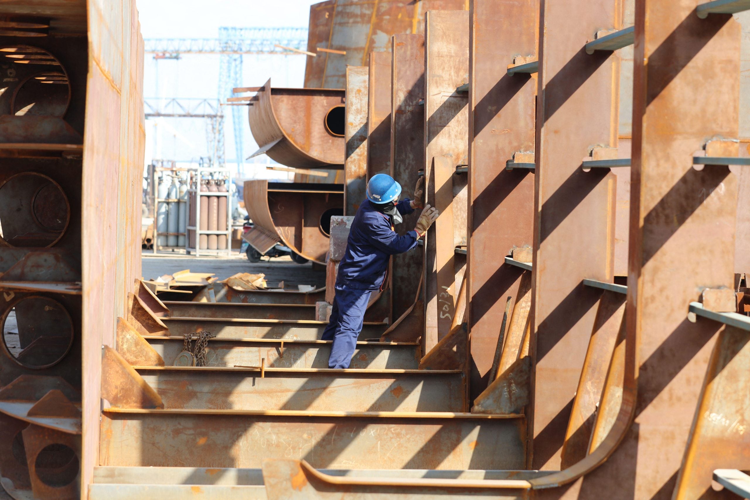 Workers building ship hull