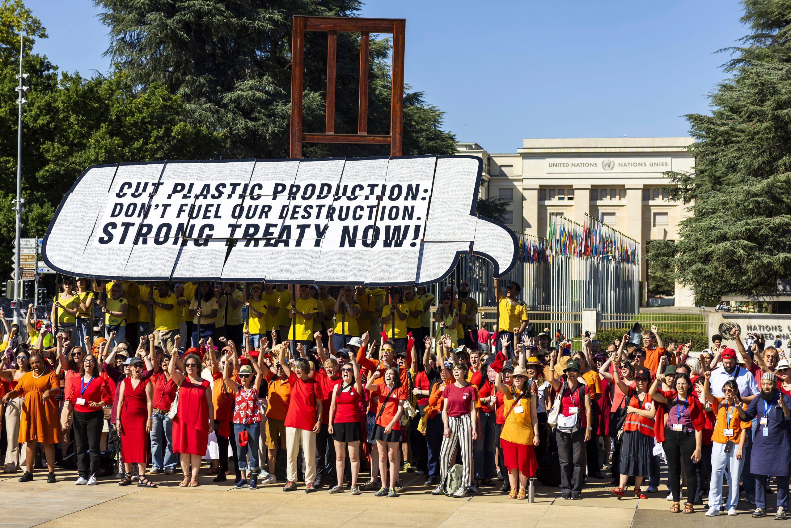 crowd of people holding large sign