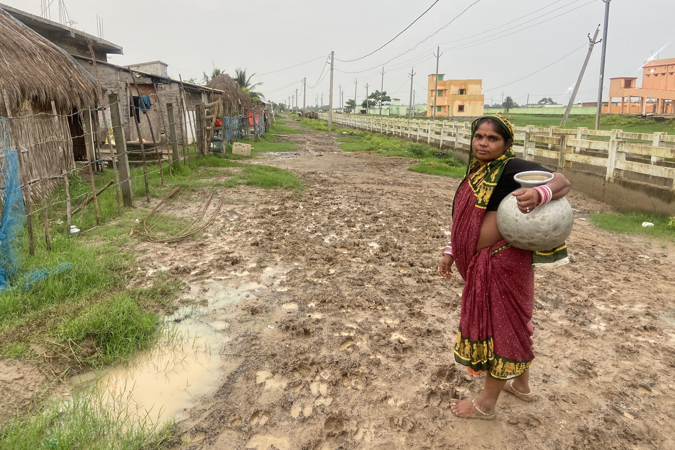 <p>A resident of Bagapatia carries hand-pumped water back to her home (Image: Dimple Behal)</p>