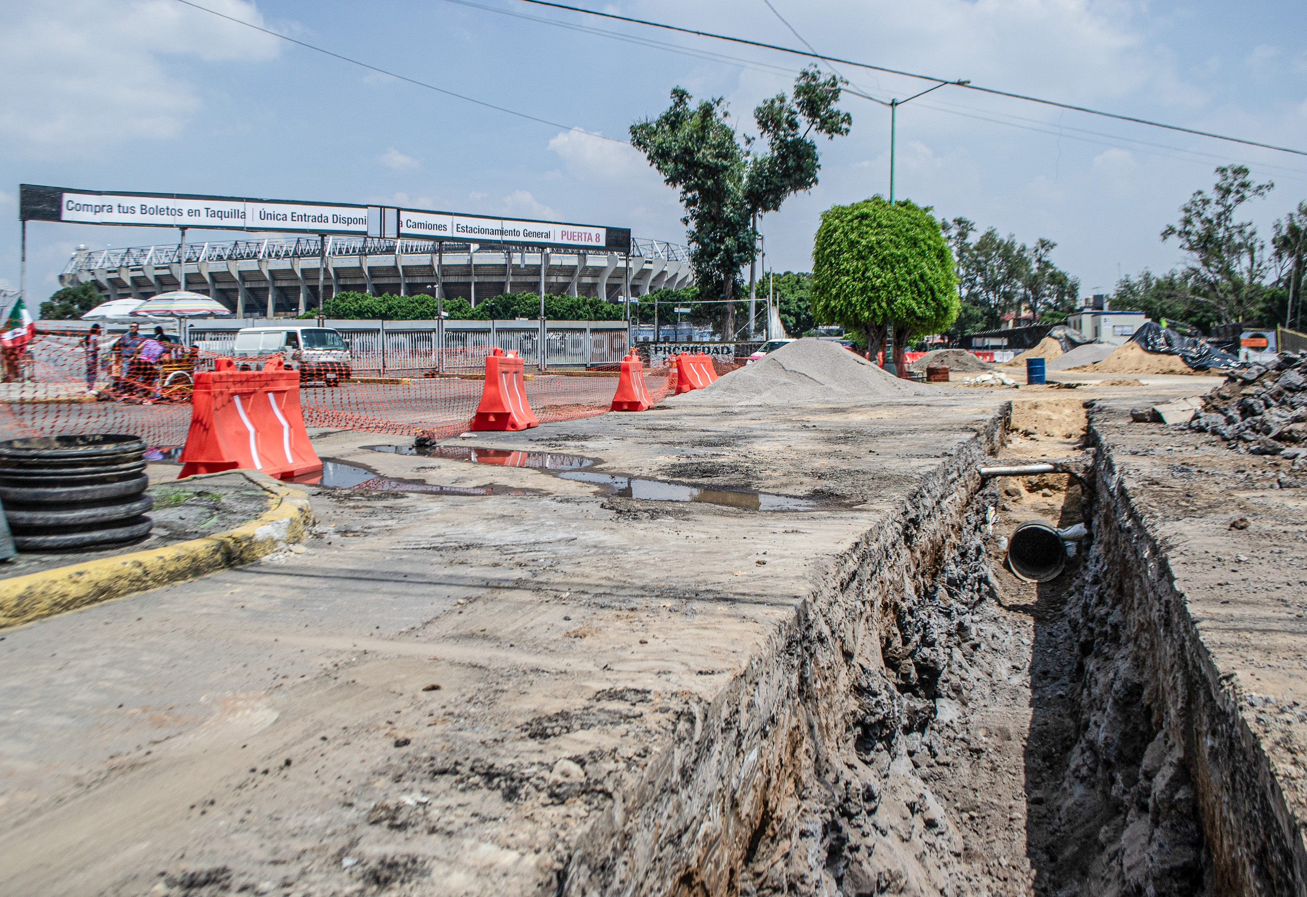 open drainage pipe beneath dug up concrete road