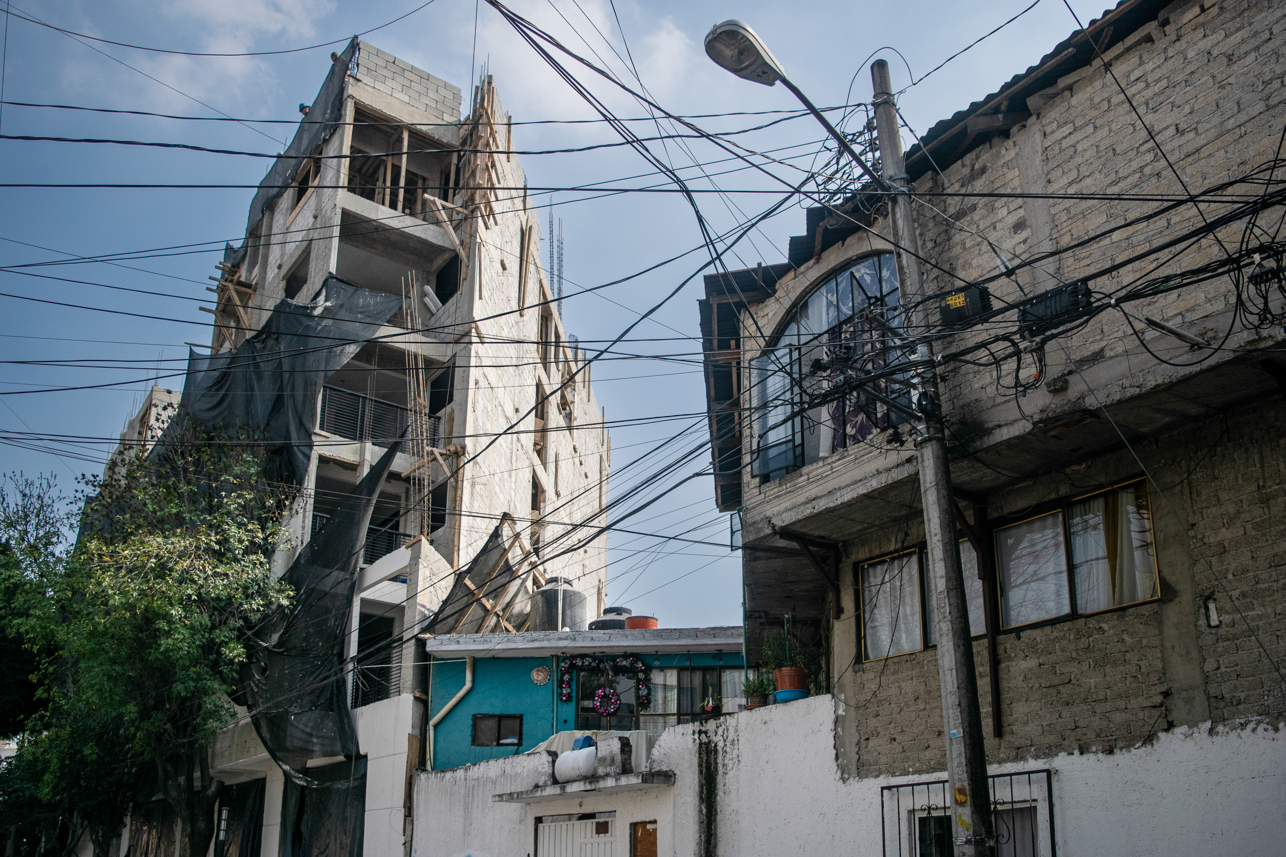 street cables crossing in front of tower block