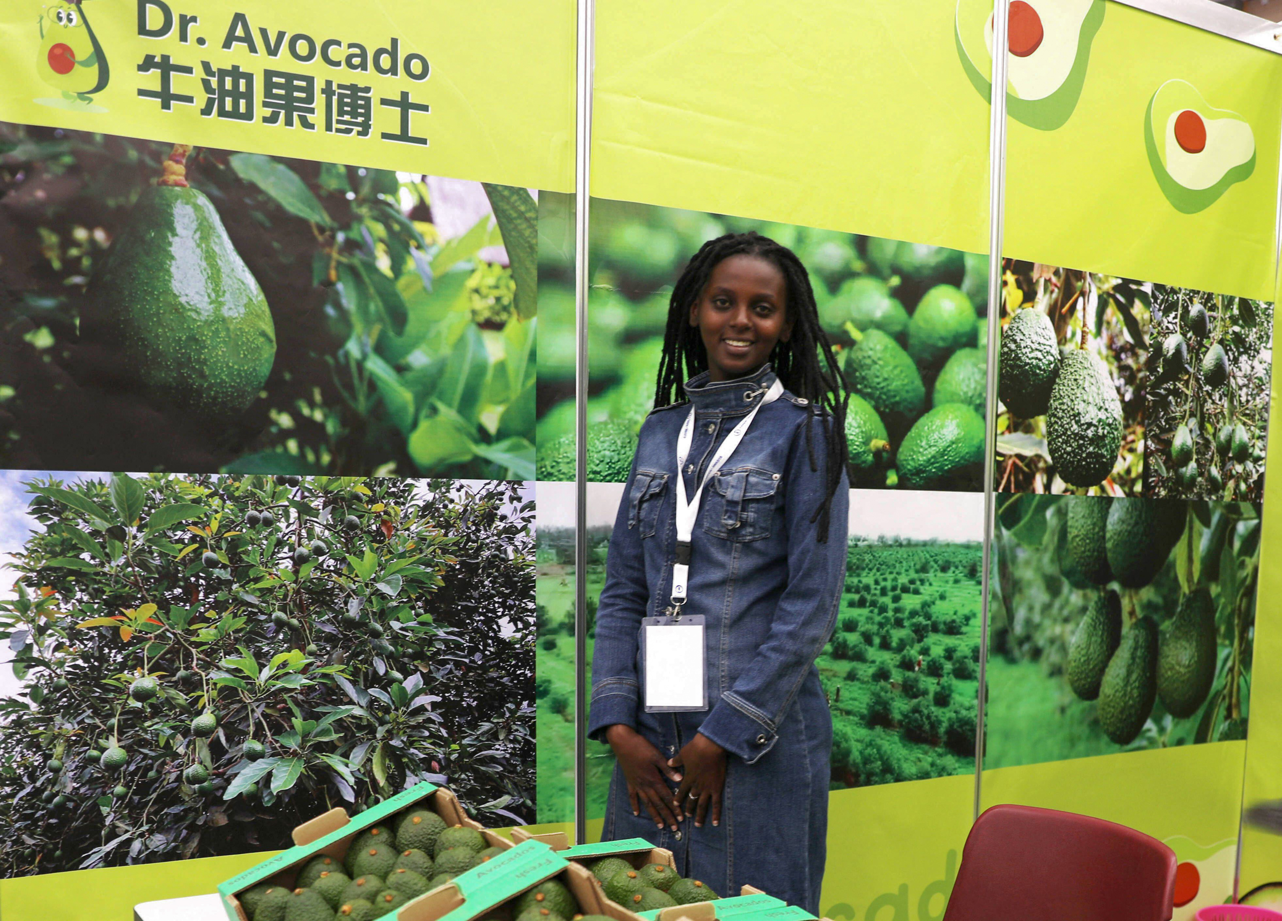 woman standing near display of avocados