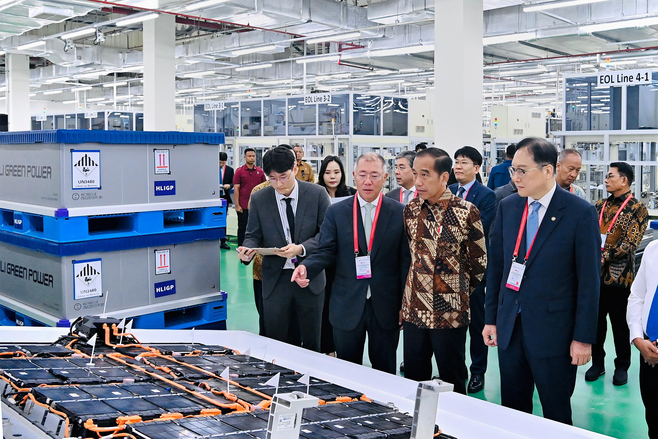 group of people in business wear observing large battery cells