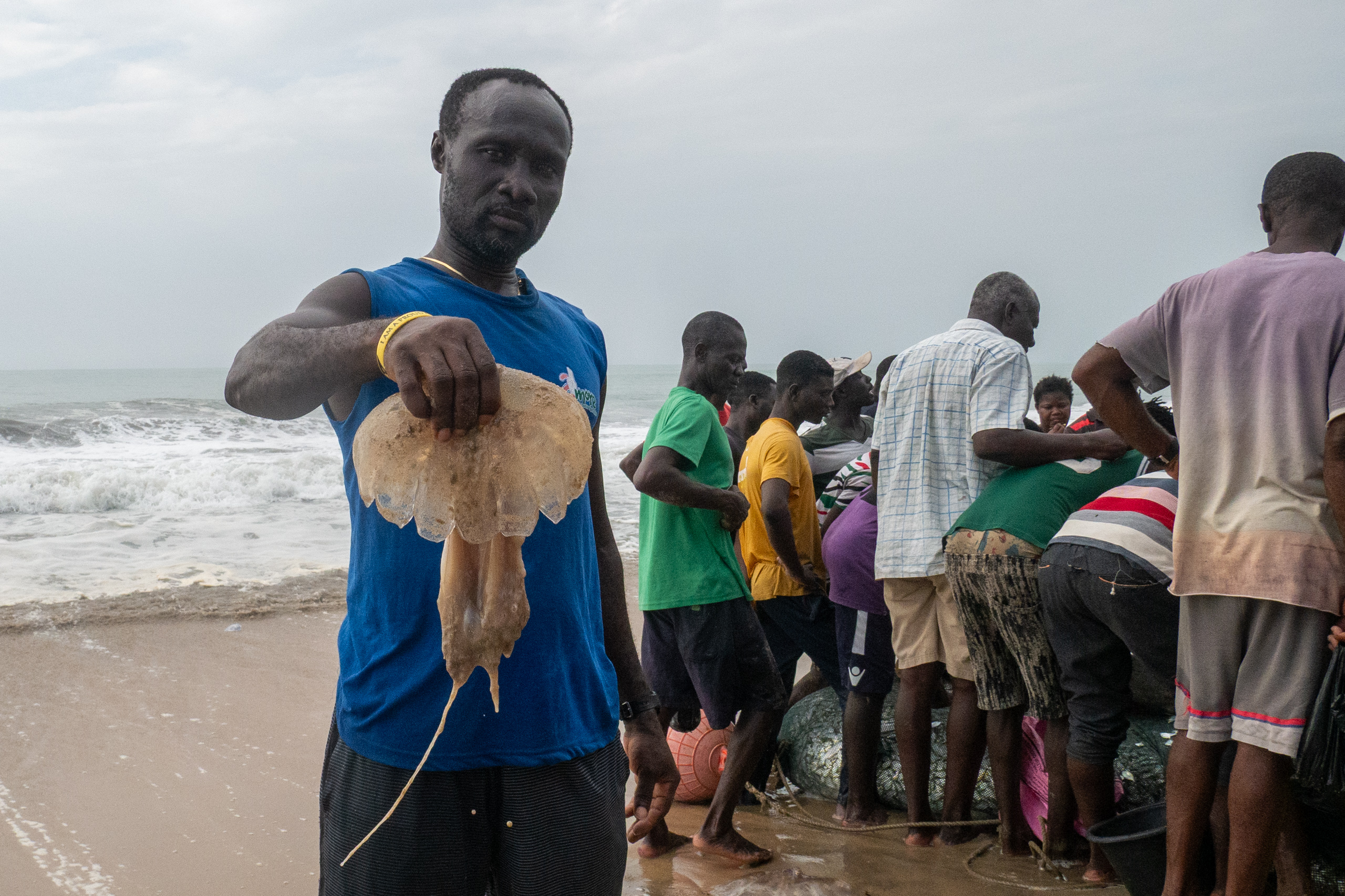man holding jellyfish behind crowd