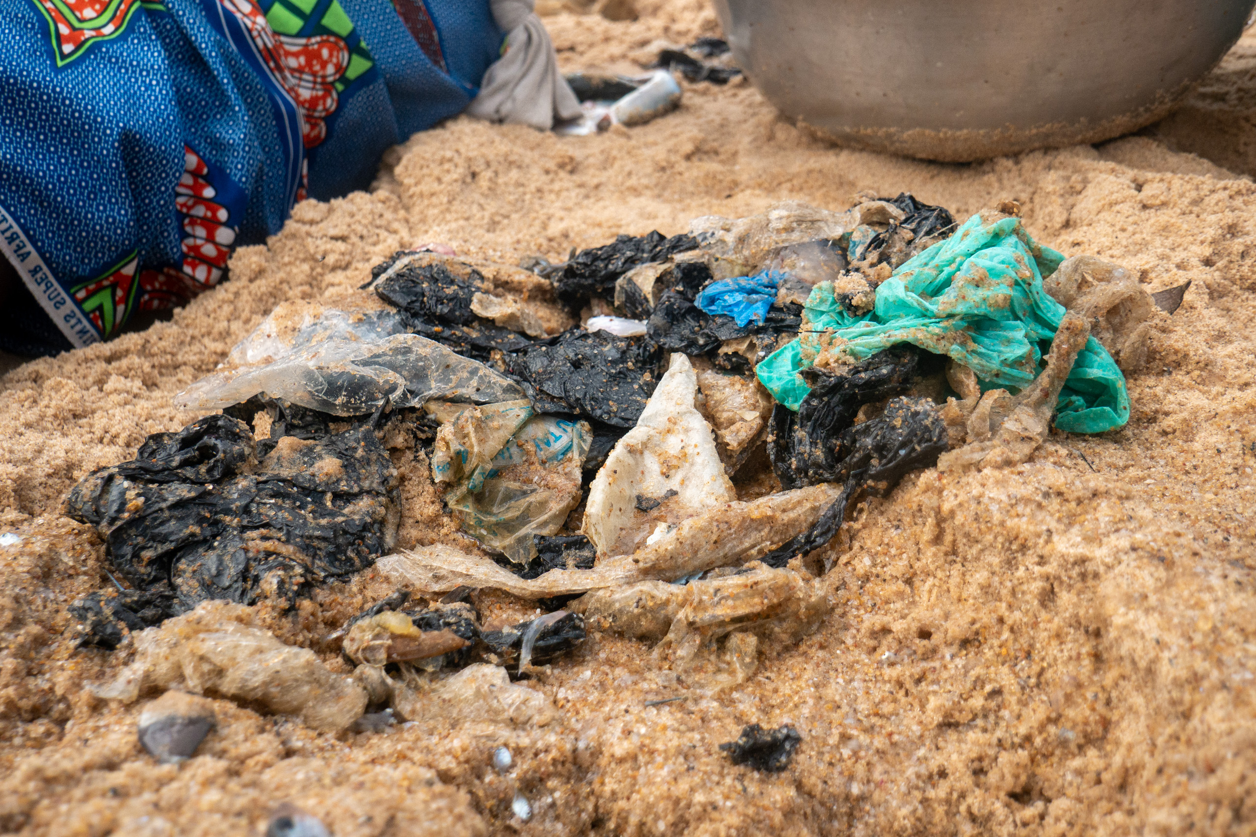 A pile of plastic discarded on a sandy beach