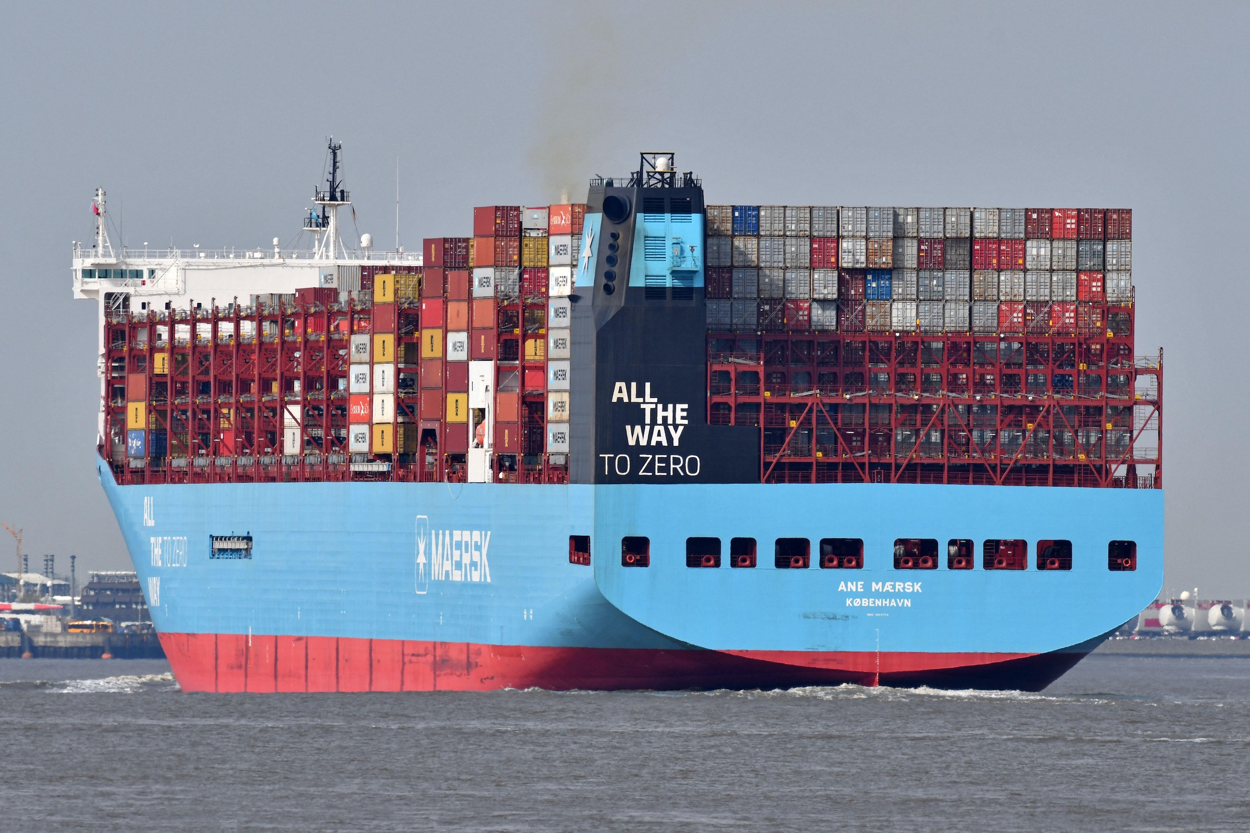 A large cargo ship with shipping containers visible on its deck in the water