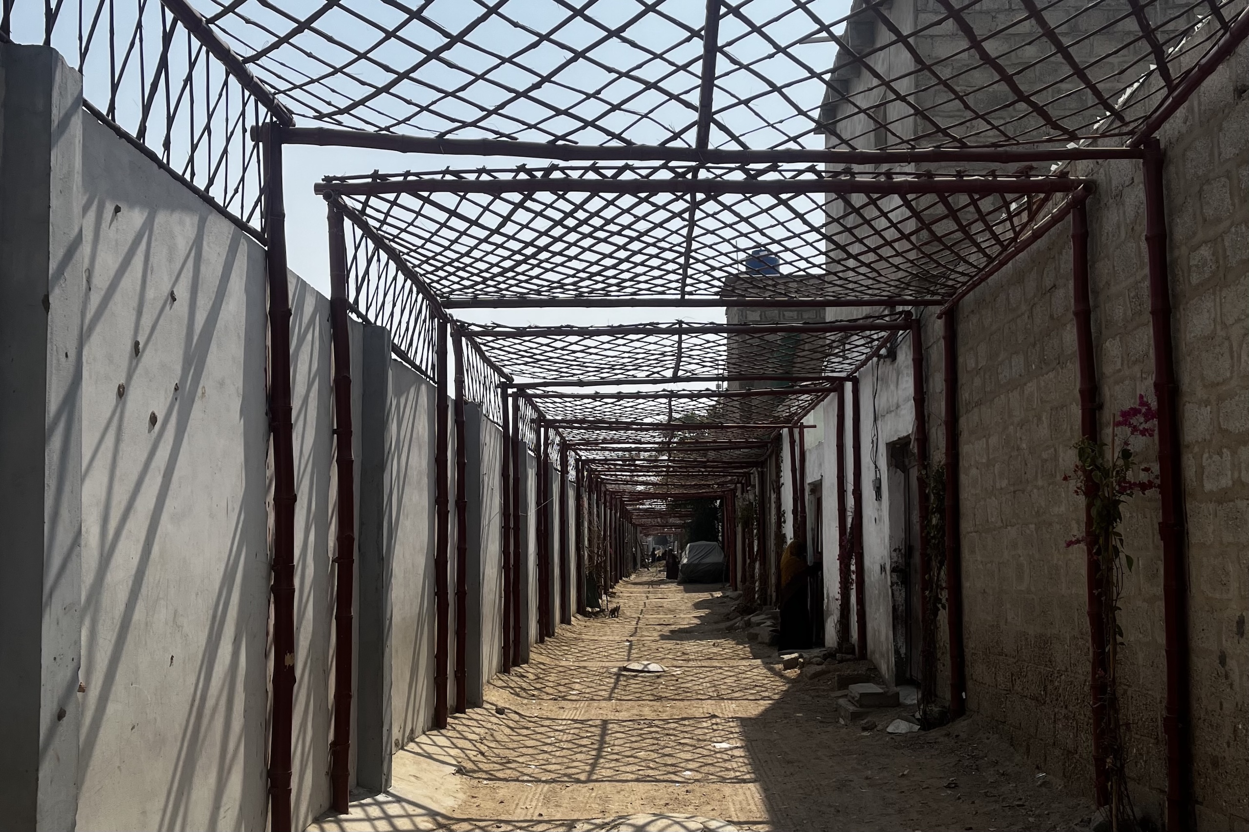 Bamboo poles creating a shaded alleyway 