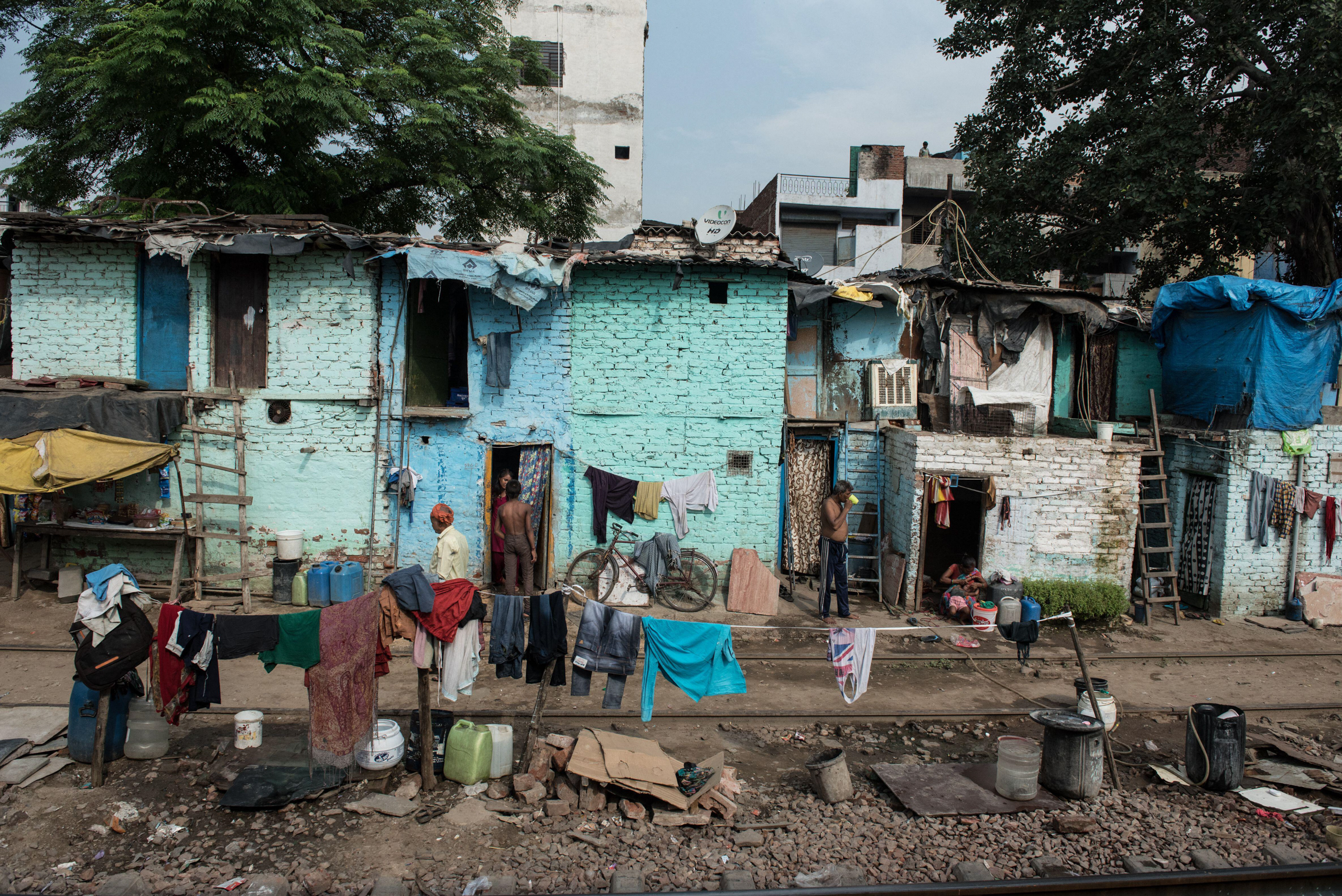 Crowded slums alongside the train tracks