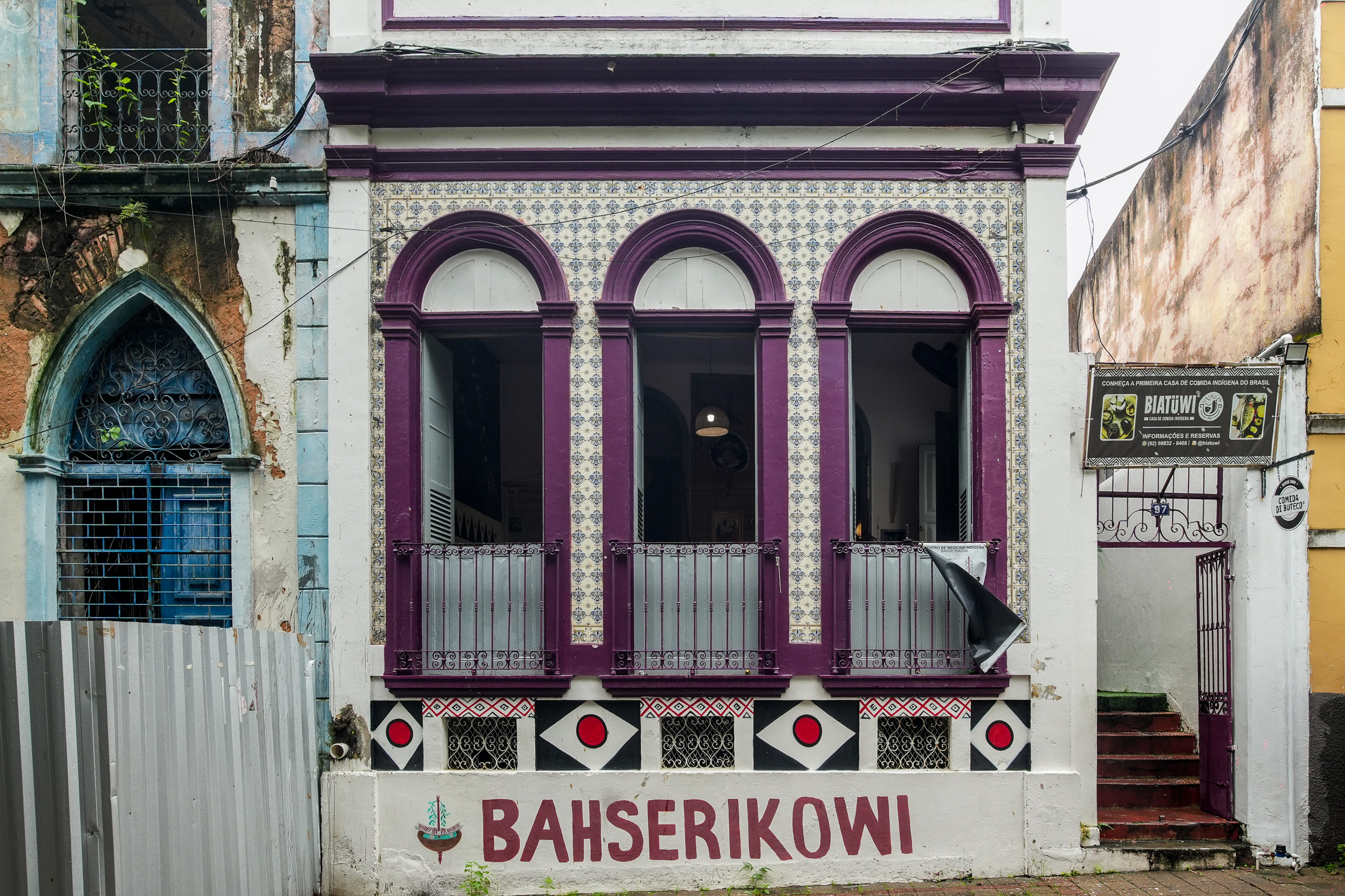 white building with purple painted arches