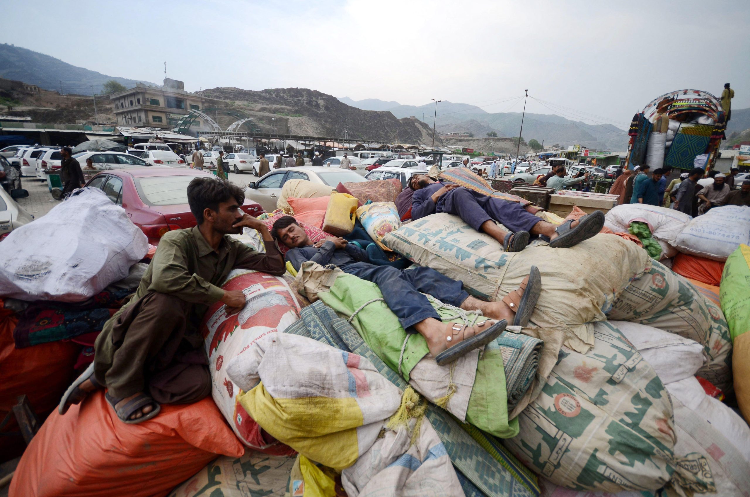 men lying on heap of sacks