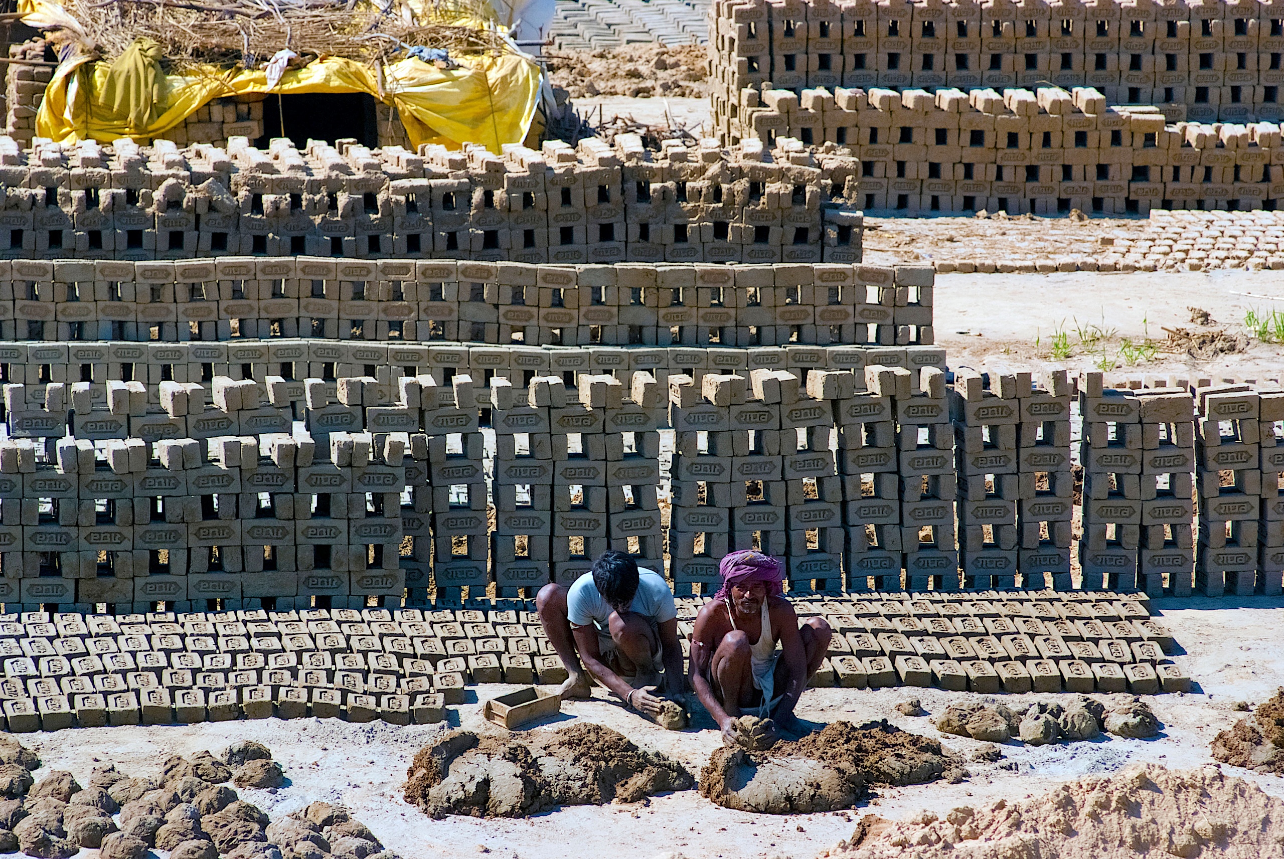 <p>Labourers prepare bricks at a kiln in Uttar Pradesh, where outdoor workers often endure extreme heat with little access to shade, cooling or healthcare protections (Image: Gnomeandi / Alamy)</p>