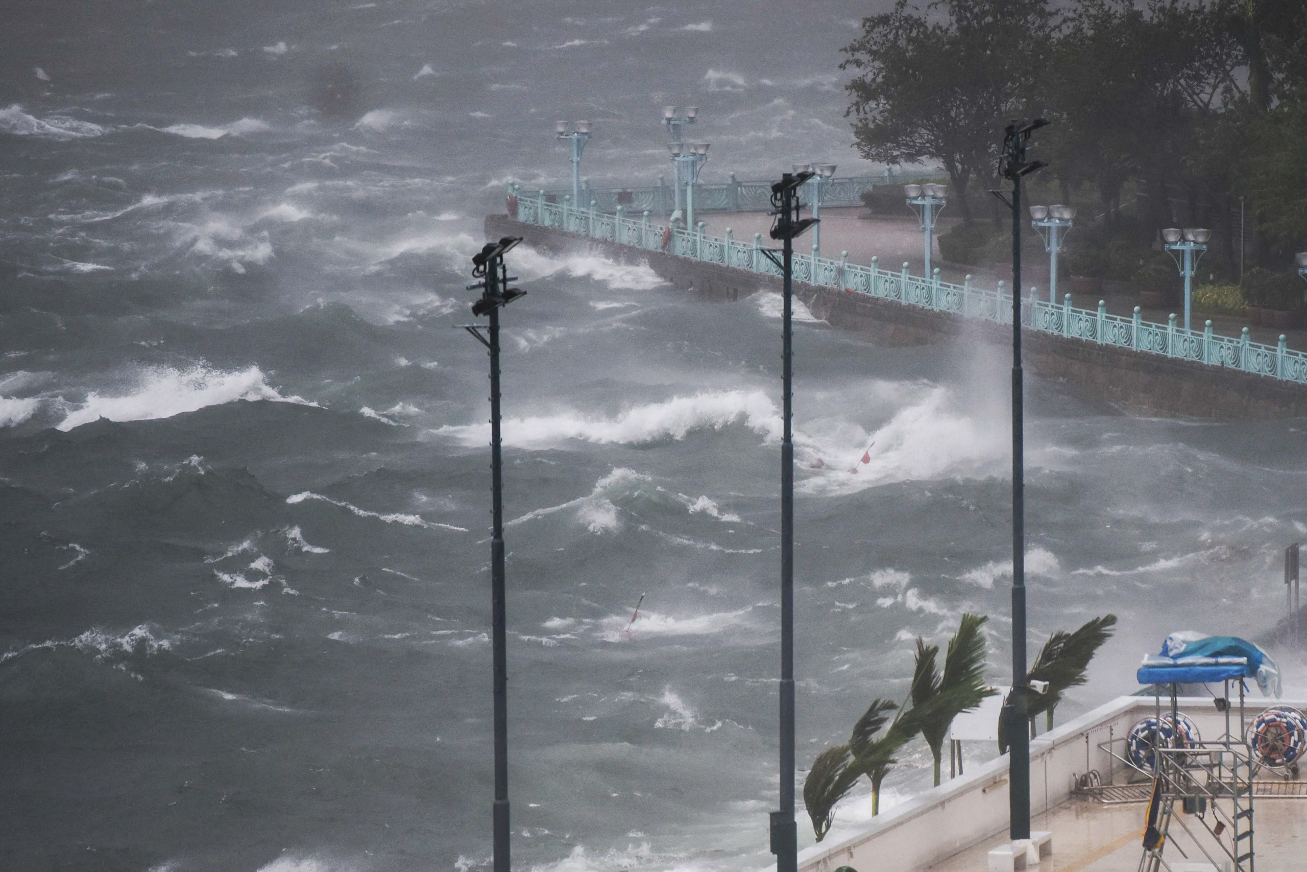 Waves crash against a harbour during a severe storm