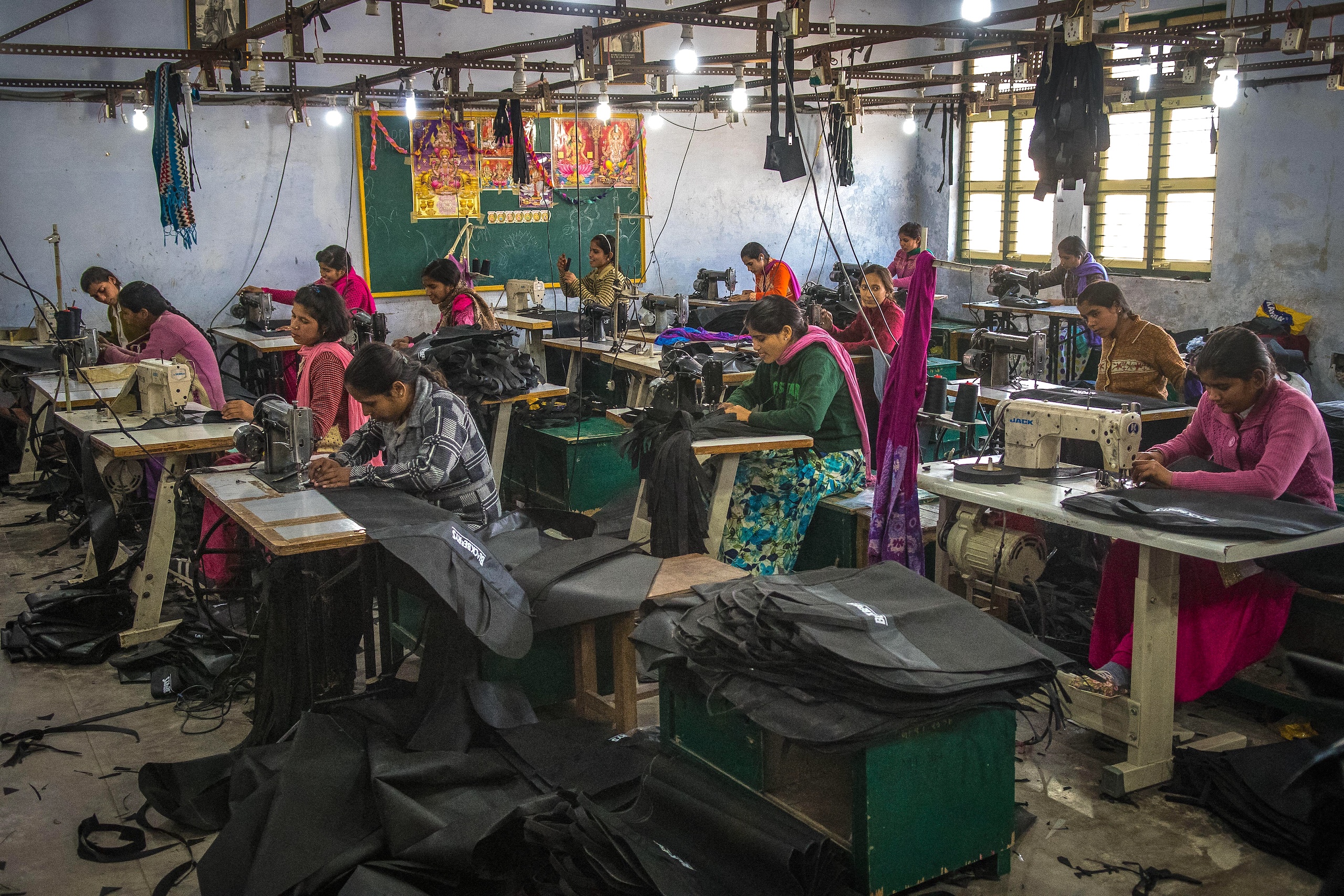 A group of femal workers, sewing fabric in a textile workshop