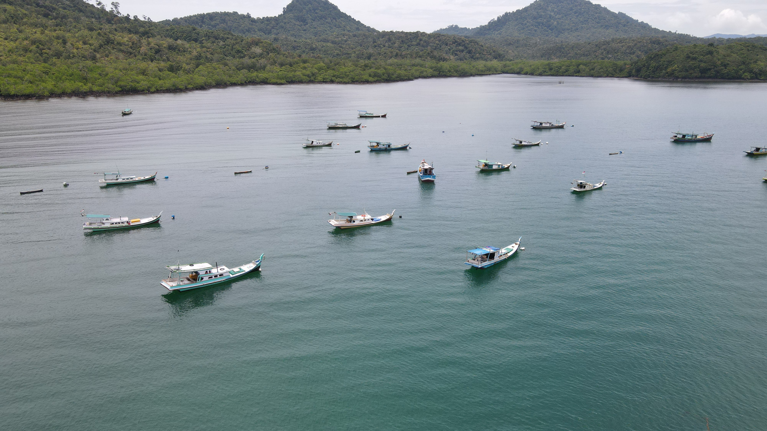 boats on sea near island