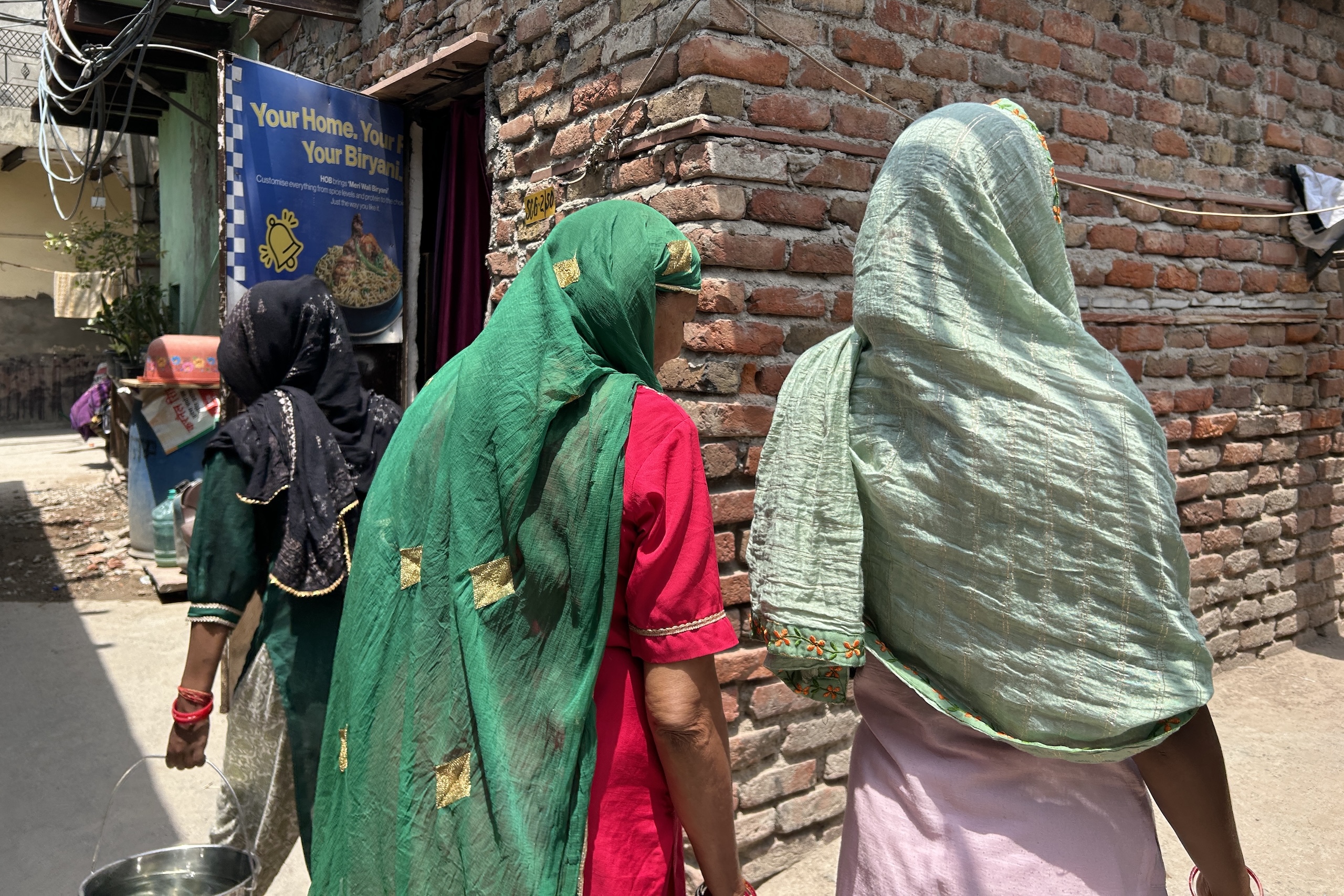<p>Poonam (right) and her mother-in-law Kaanta Devi outside their home in Shahbad Dairy, Delhi, where crowded housing and limited ventilation intensify the effects of extreme heat (Image: Shalinee Kumari / Dialogue Earth)</p>
