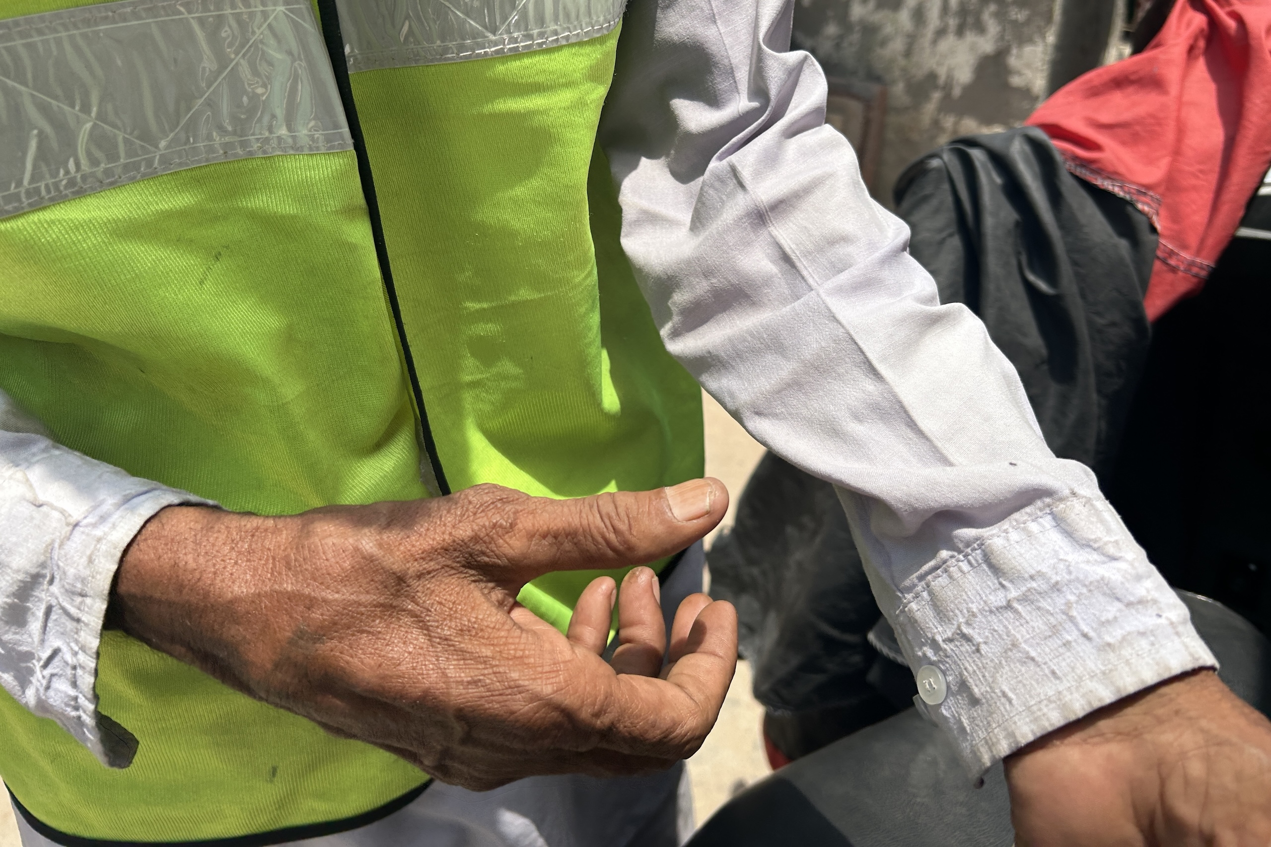 fluorescent vest over cotton shirt