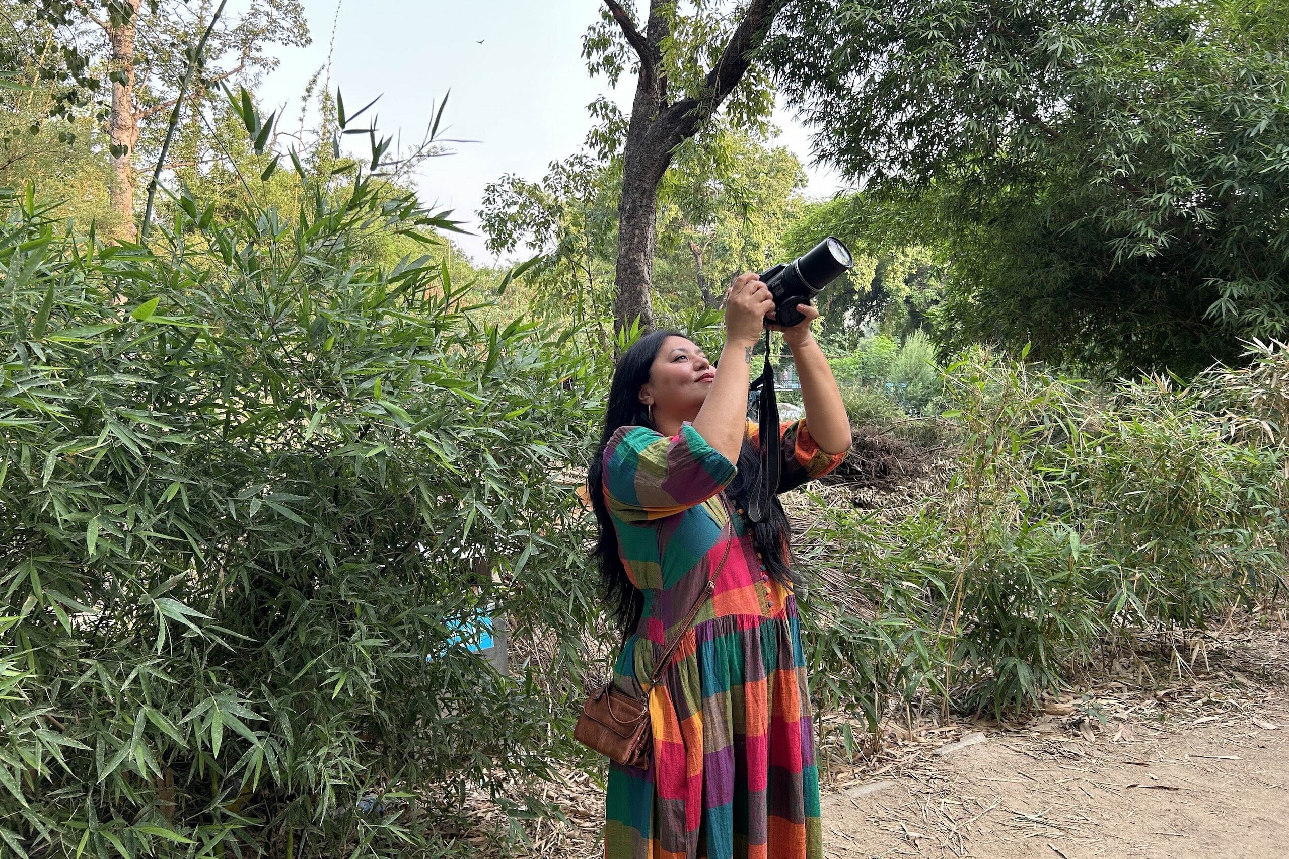 <p>Neha Sinha, the author of Wild Capital, at Delhi’s Lodhi Garden photographing its resident Oriental pied hornbill. The city is highly rich in biodiversity, but Sinha fears that “if we don’t see that richness, we won’t value it” (Image: Shalinee Kumari / Dialogue Earth)</p>