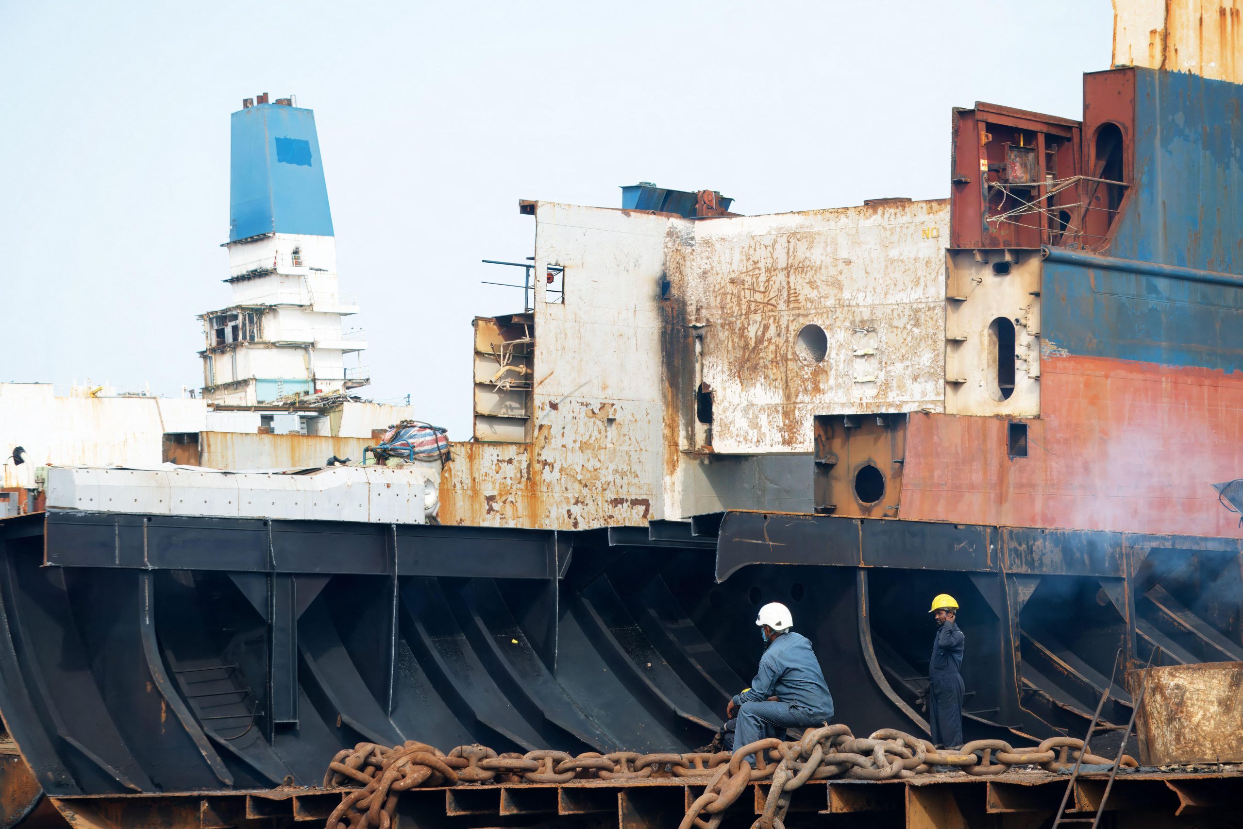 two men weareing hard hats near ship