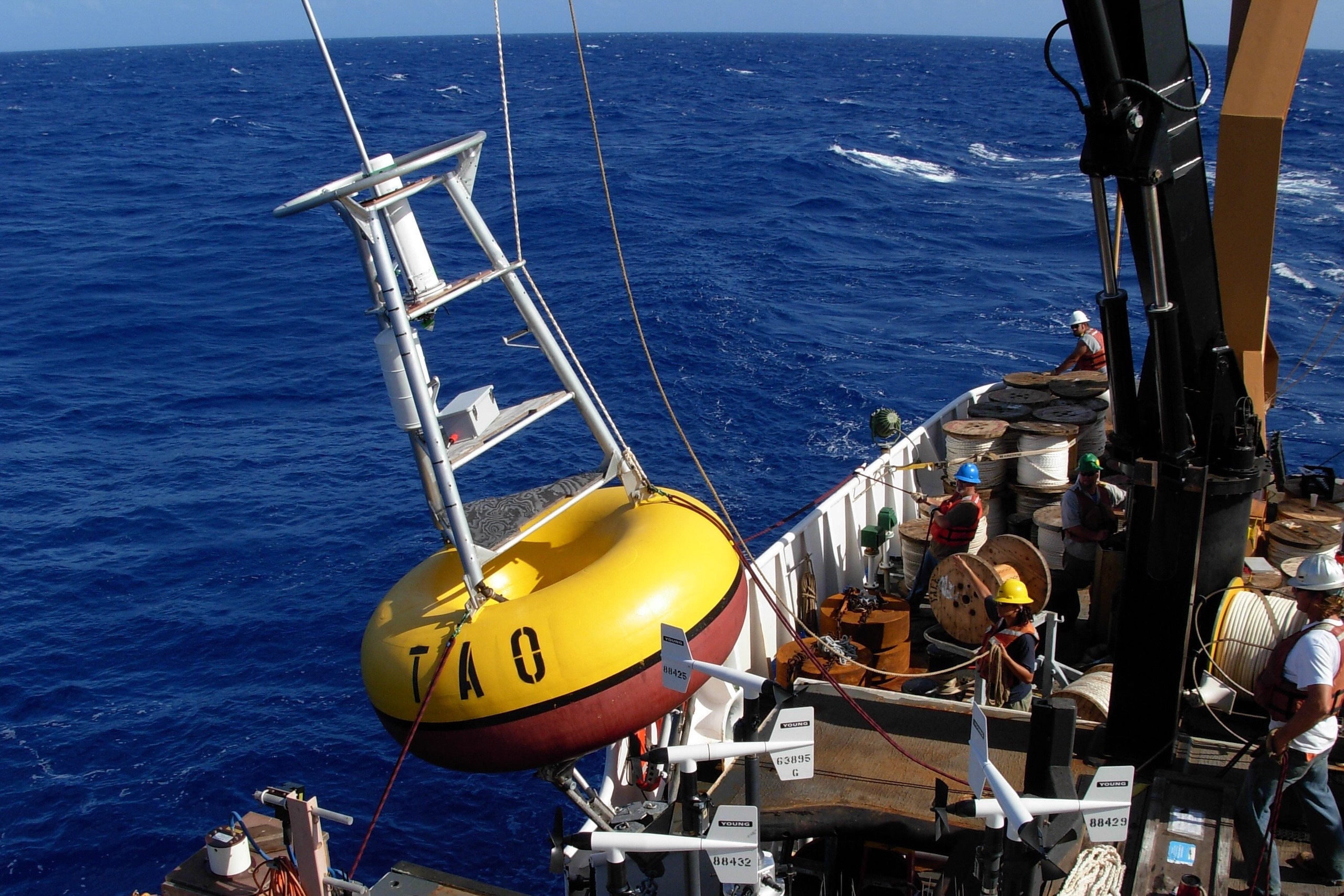 Crew members prepare to launch a buoy during an operations at sea