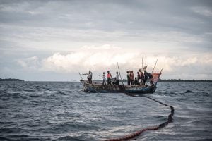 A group of people on a fishing boat in the ocean