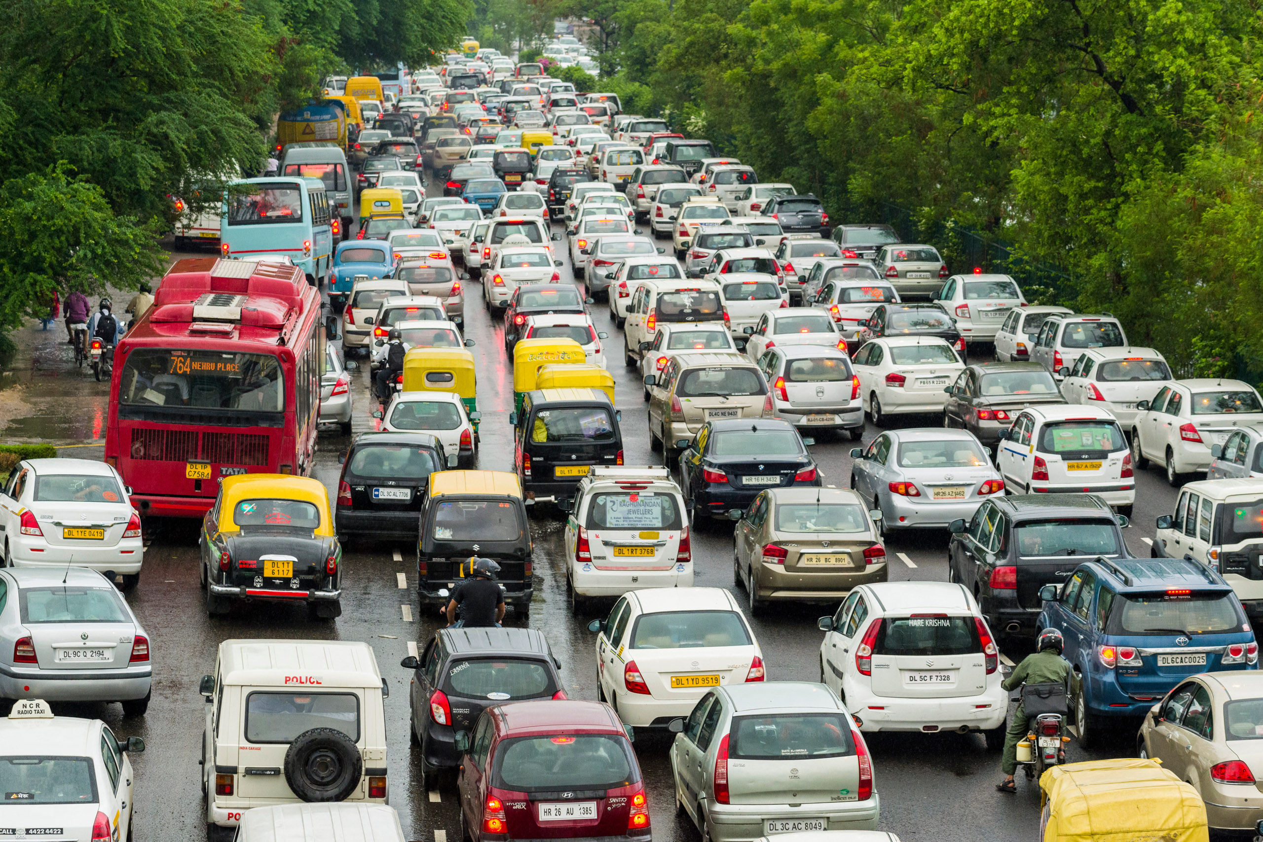 multiple lanes of cars and busses stopped in traffic