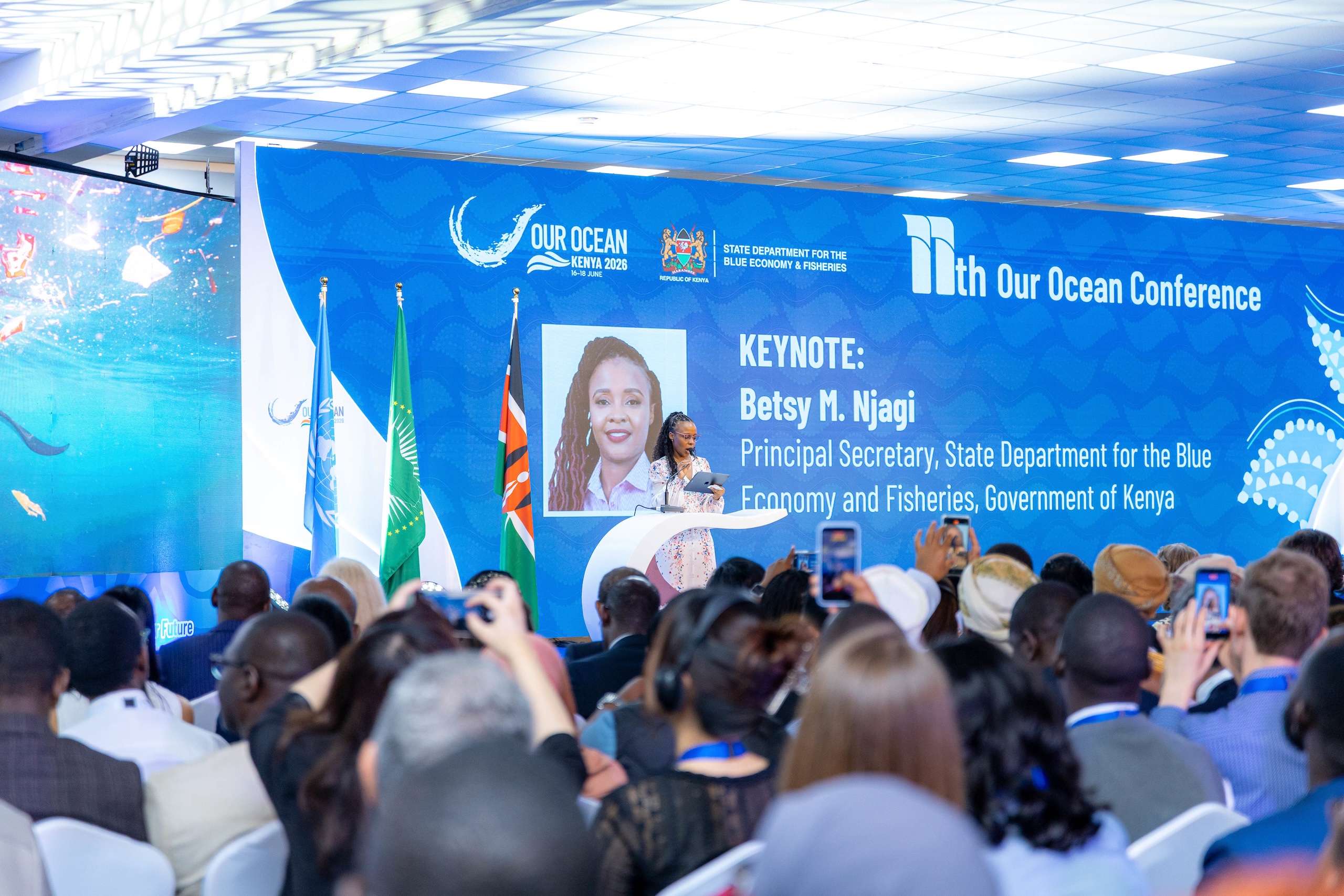A woman gives a speech to audience at a conference