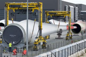 A large wind turbine is being shipping at a port