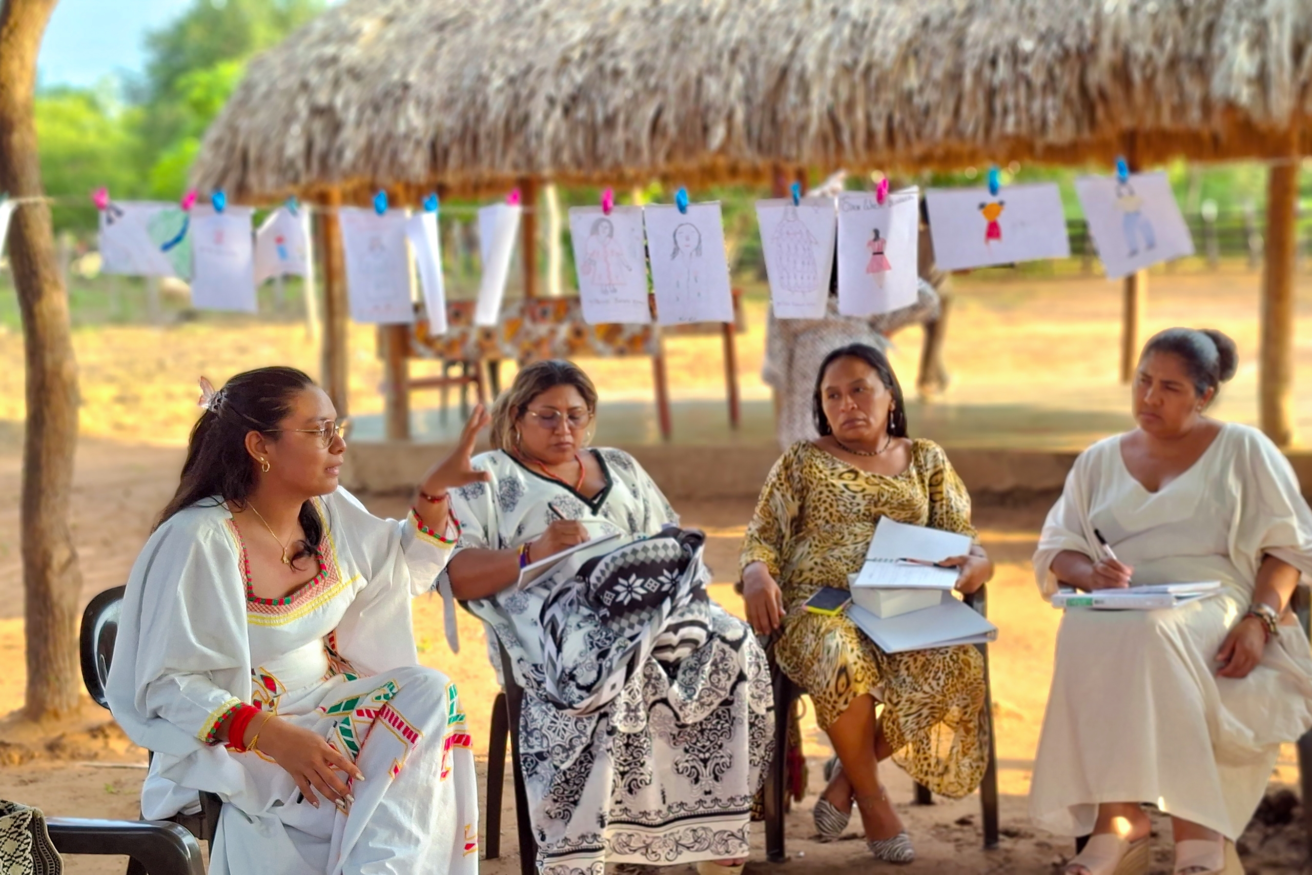 four women seated outdoors