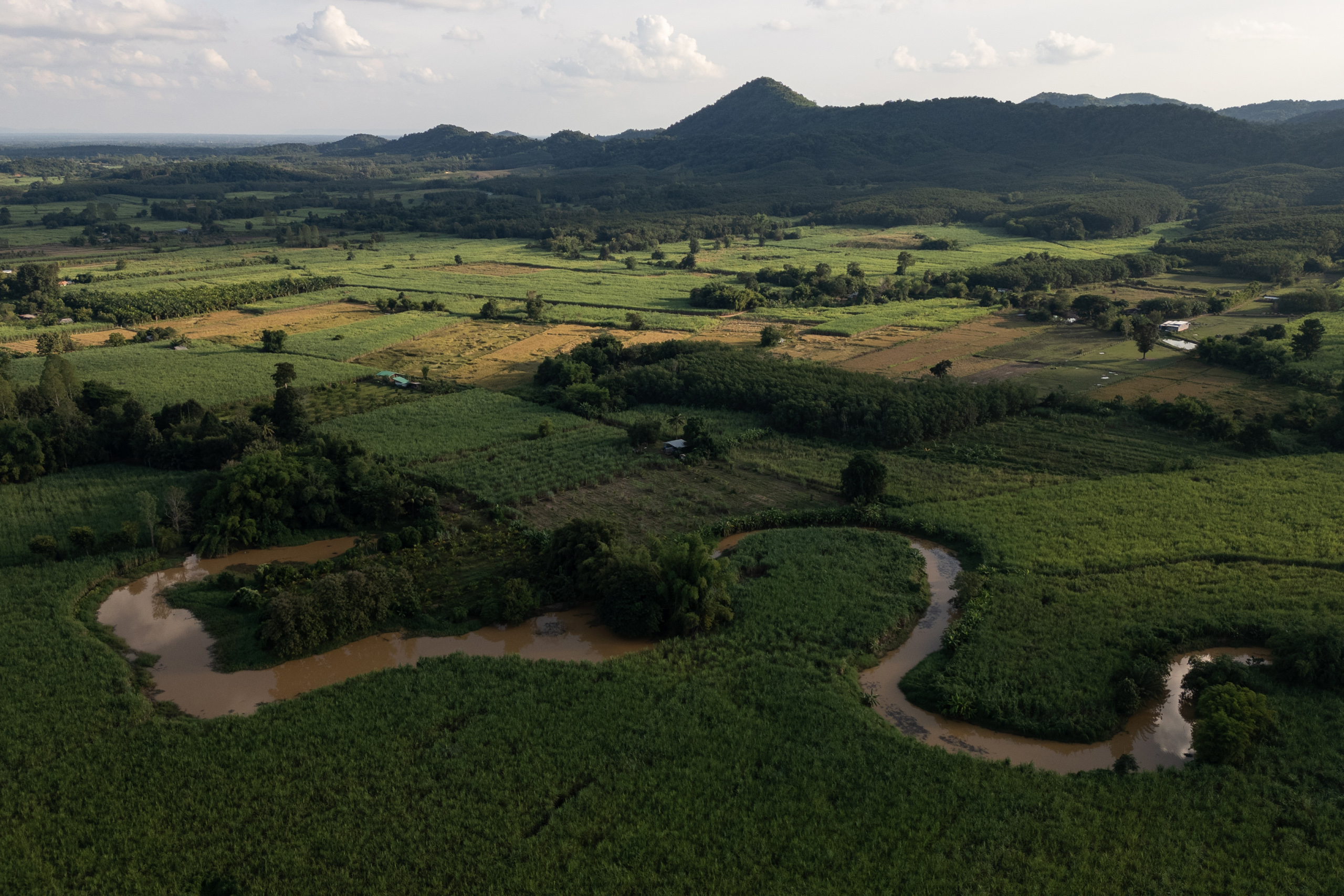 Aerial view of a winding river surrounded by farming fields