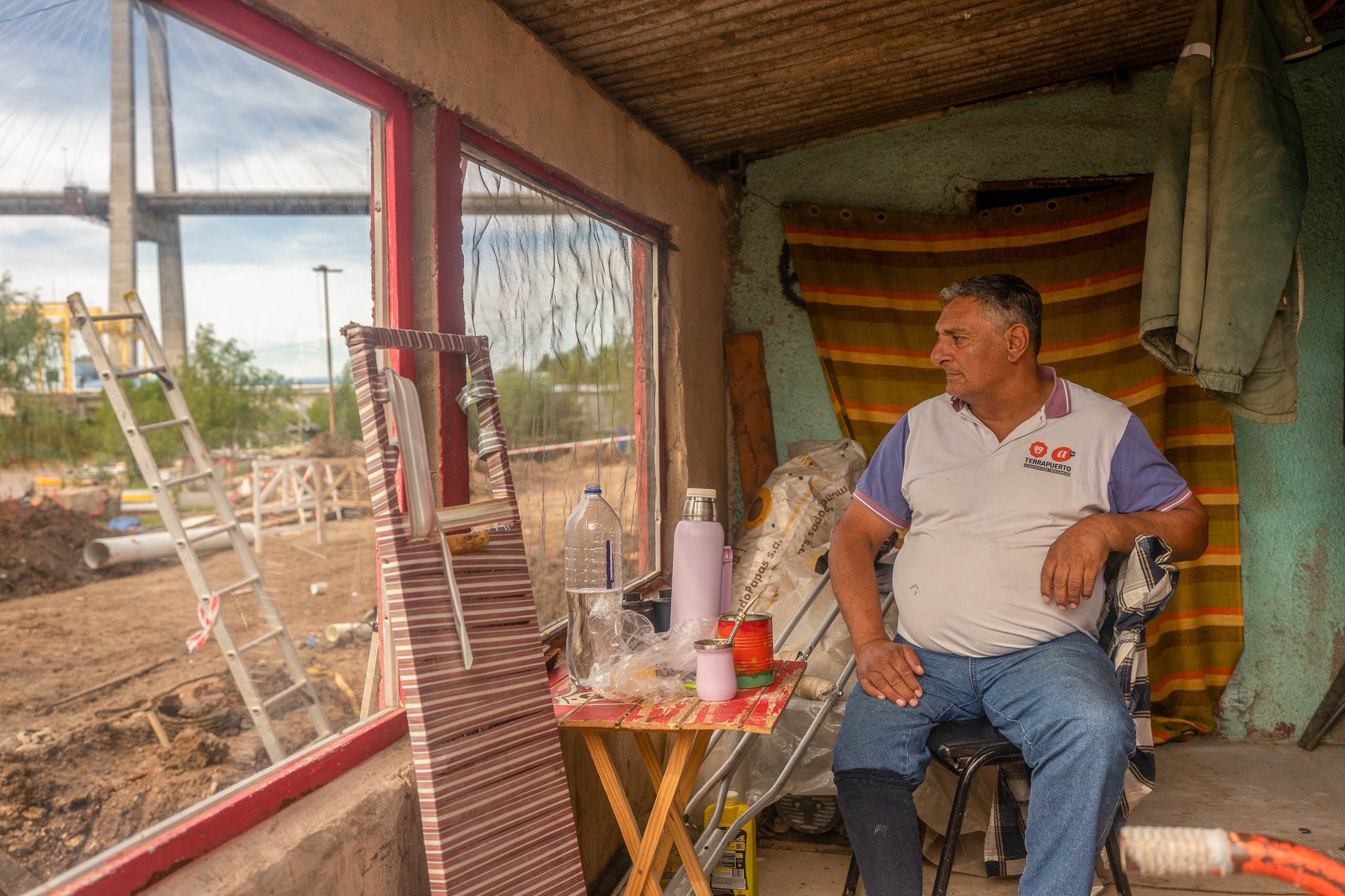 Man sitting by window in rustic shelter