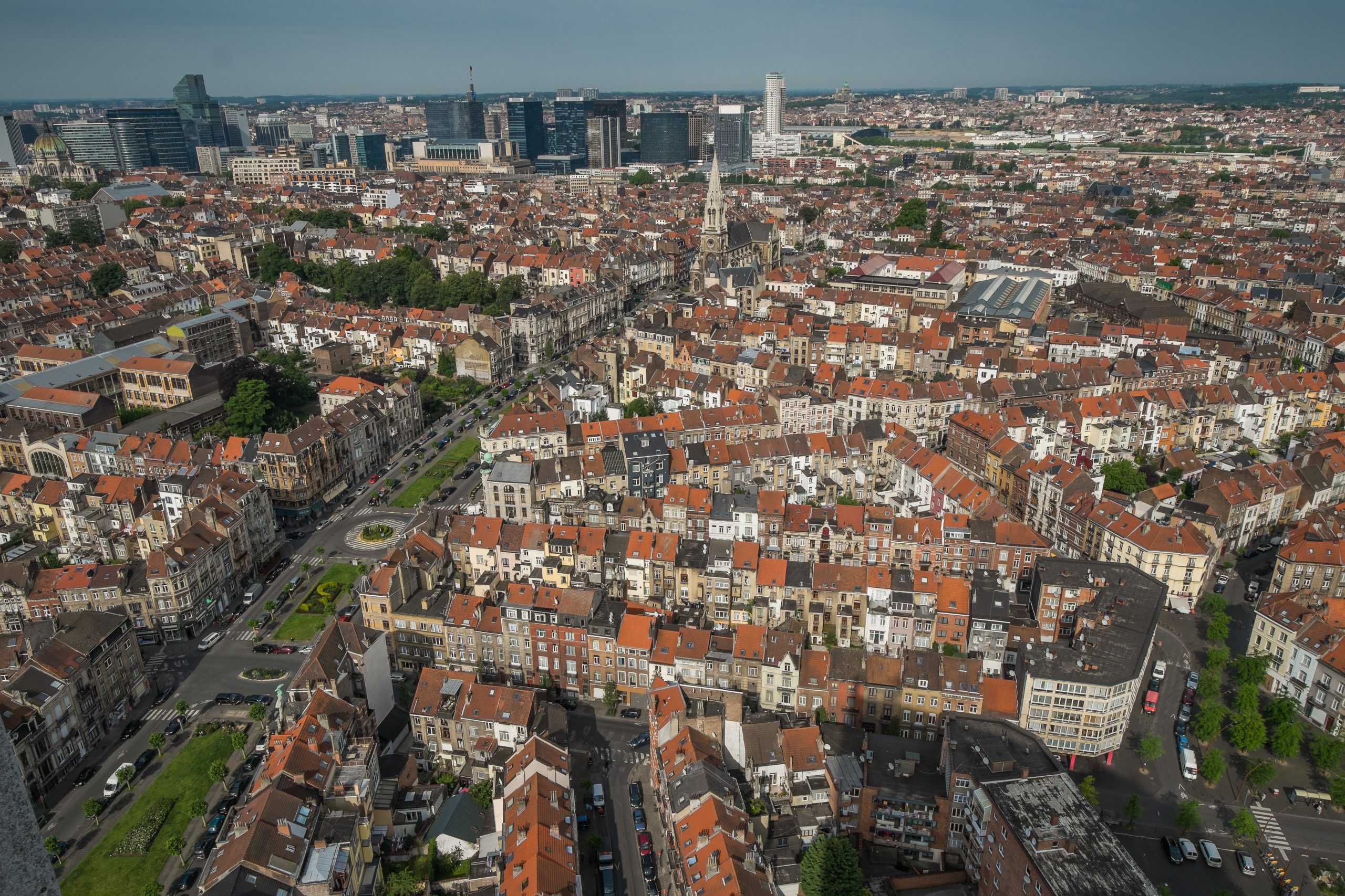 Aerial view of Brussels, Belgium, featuring a mix of residential, commercial, and green areas
