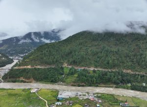 low clouds over green hill