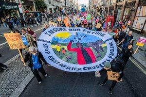 Protesters marching with 'Insure Our Future' banner