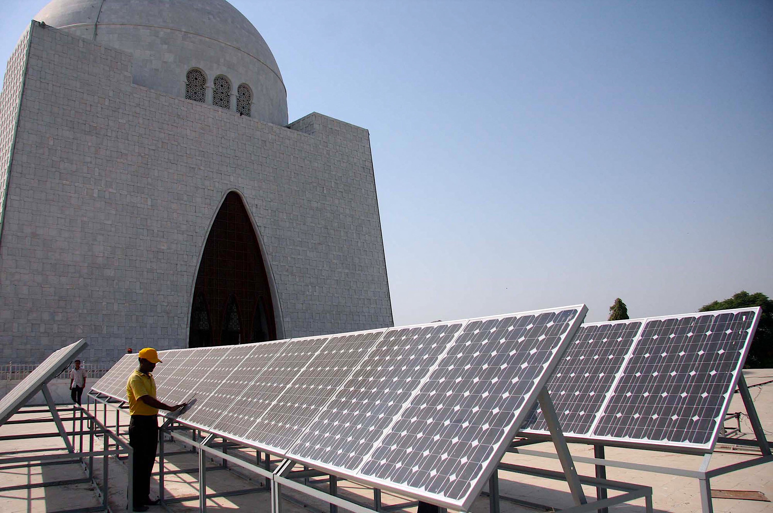 <p>Solar panels need frequent cleaning which is often done in the hottest part of the day without adequate protective gear (Image: Rizwan Ali / Pakistan Press International / Alamy)</p>