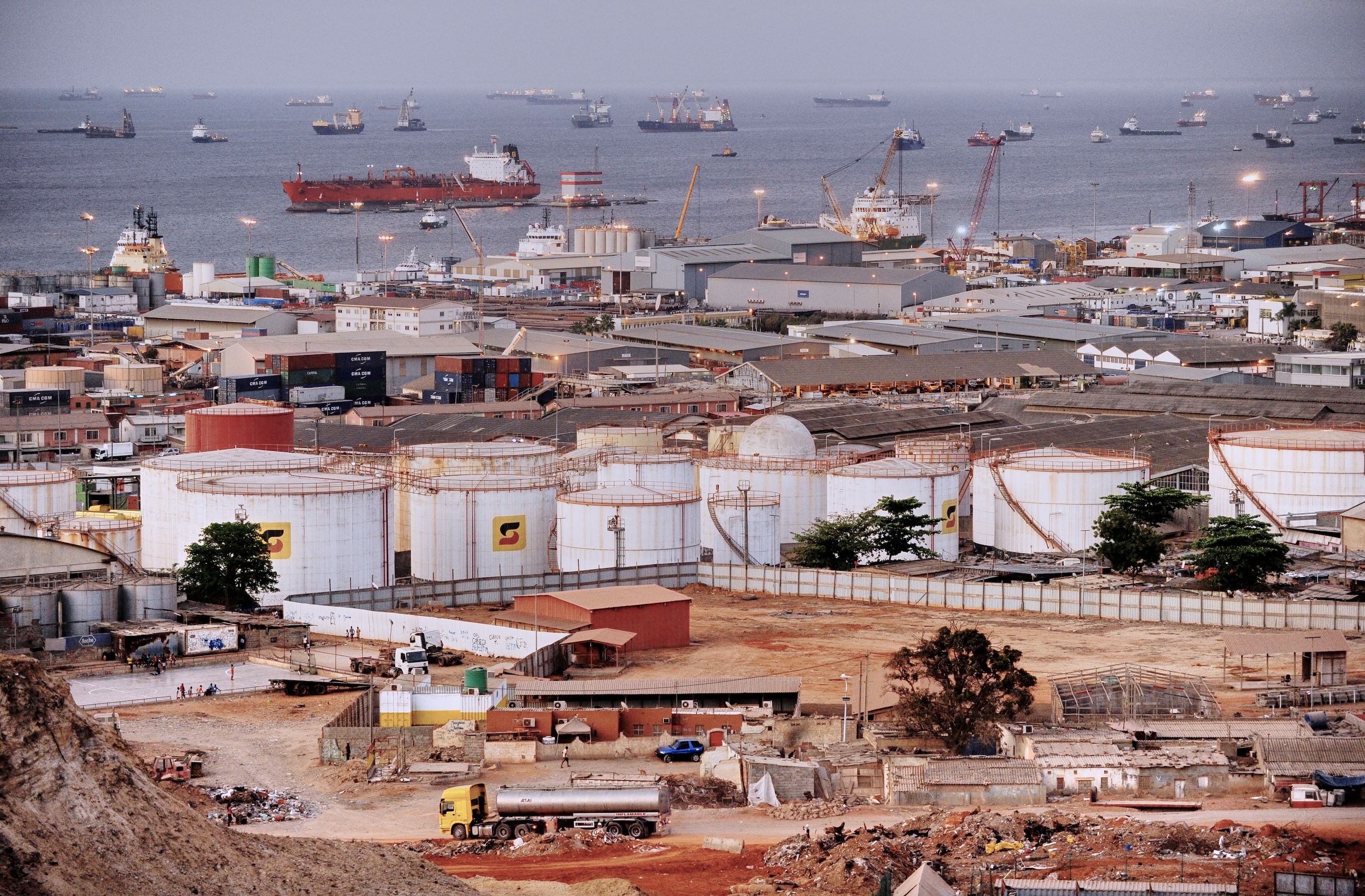 Industrial port area with oil storage tanks and cargo ships