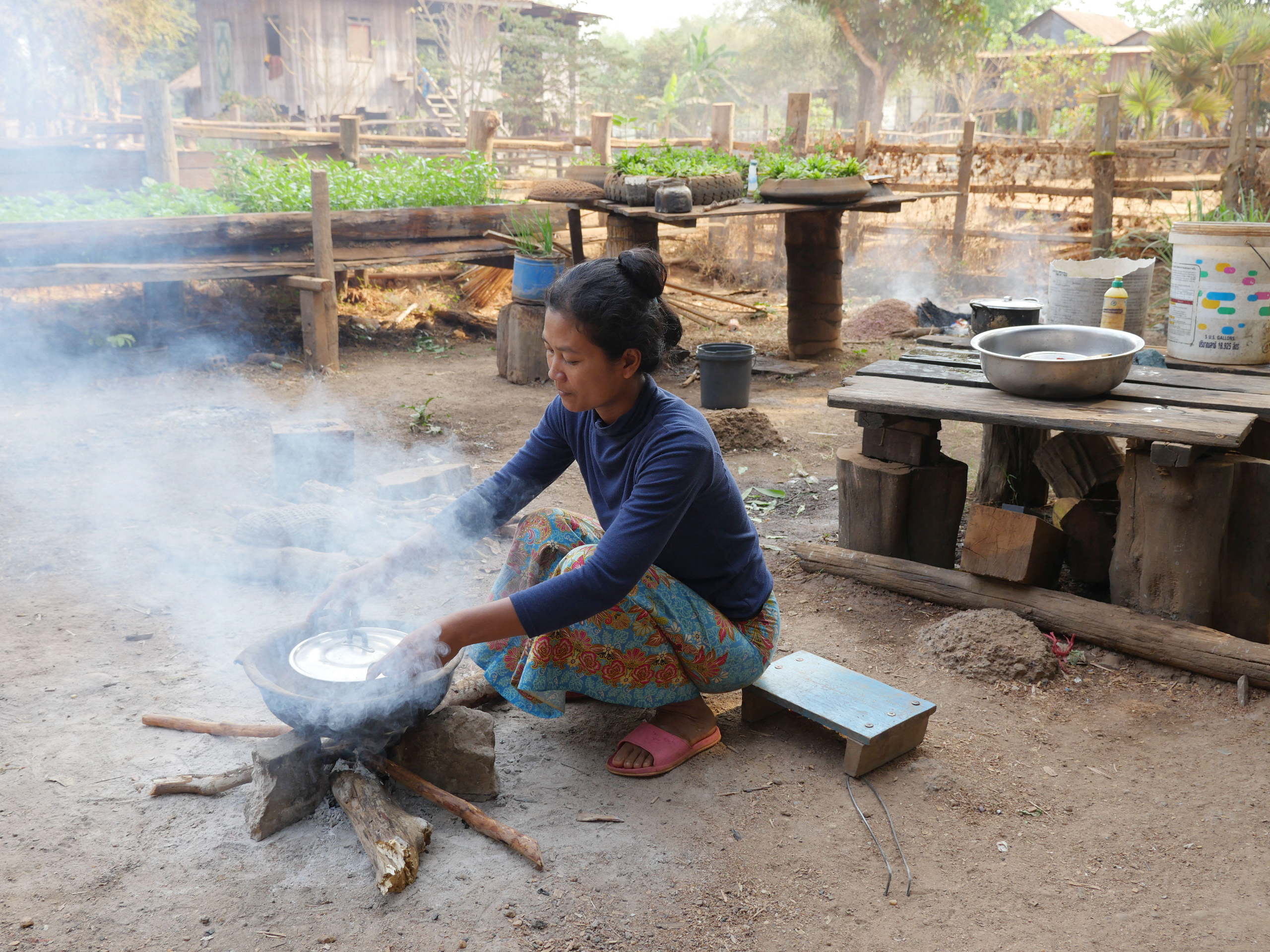 <p>A woman uses a three-stone stove fuelled by wood fire to cook in Stung Treng, Cambodia. For 80% percent of households in rural Cambodia, firewood is still the primary cooking fuel, according to the Cambodia Development Resource Institute (Image: Sean Sprague / Borderlands / Alamy)</p>