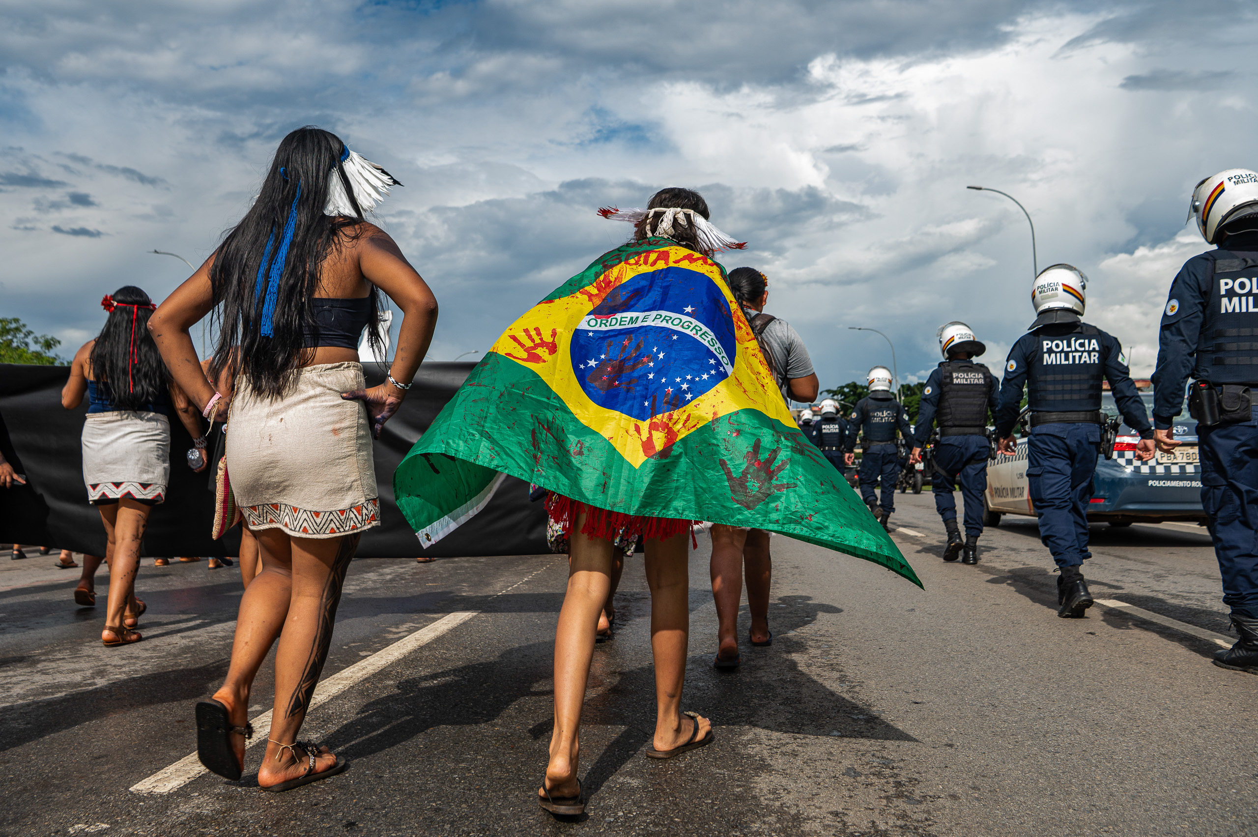 <p>A protester draped in a ‘bloodied’ Brazilian flag during an Indigenous peoples’ march against fossil fuels in Brasília, 9 April 2026 (Image: Edgar Kanaykõ Xakriabá / Dialogue Earth)</p>
