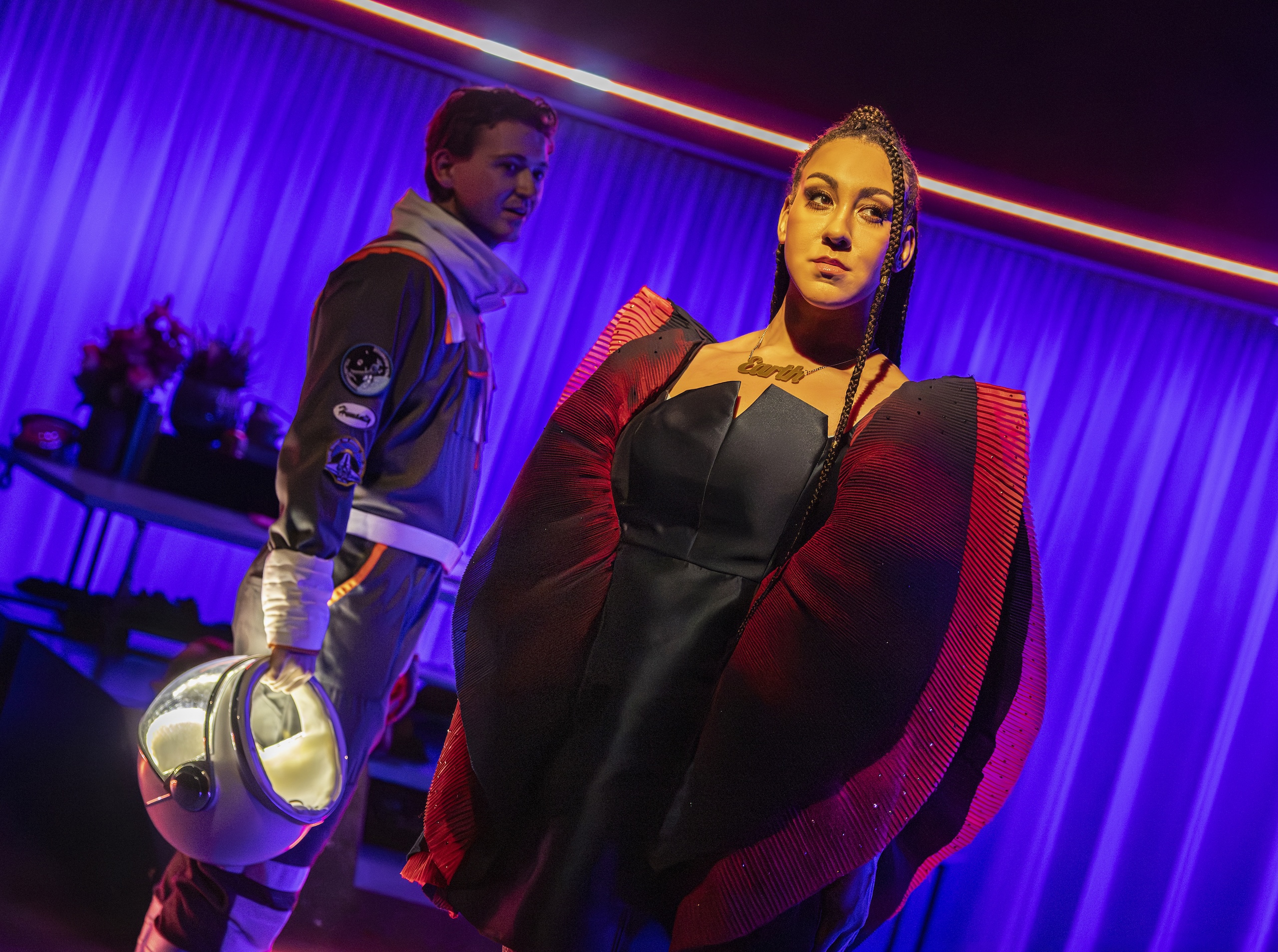 <p>Danielle Steele (right) plays the planet Mars, which Humanity, portrayed by Morgan Gregory in the spacesuit, leaves his partner Earth to begin a relationship with (Image: Pamela Raith)</p>