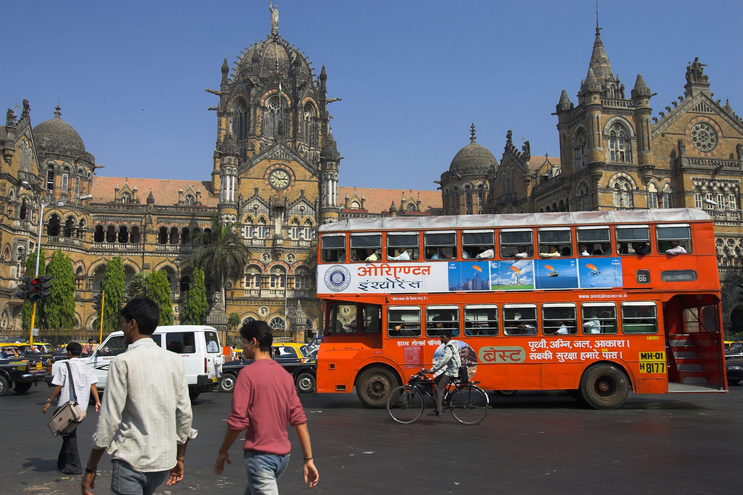 <p>A red double-decker BEST bus passes the Chhatrapati Shivaji Maharaj Terminus in Mumbai, one of India’s busiest railway stations. BEST buses transport over 5.5 million people daily, second only to the city’s arterial railway network (Image: Andrew Woodley / Alamy)</p>