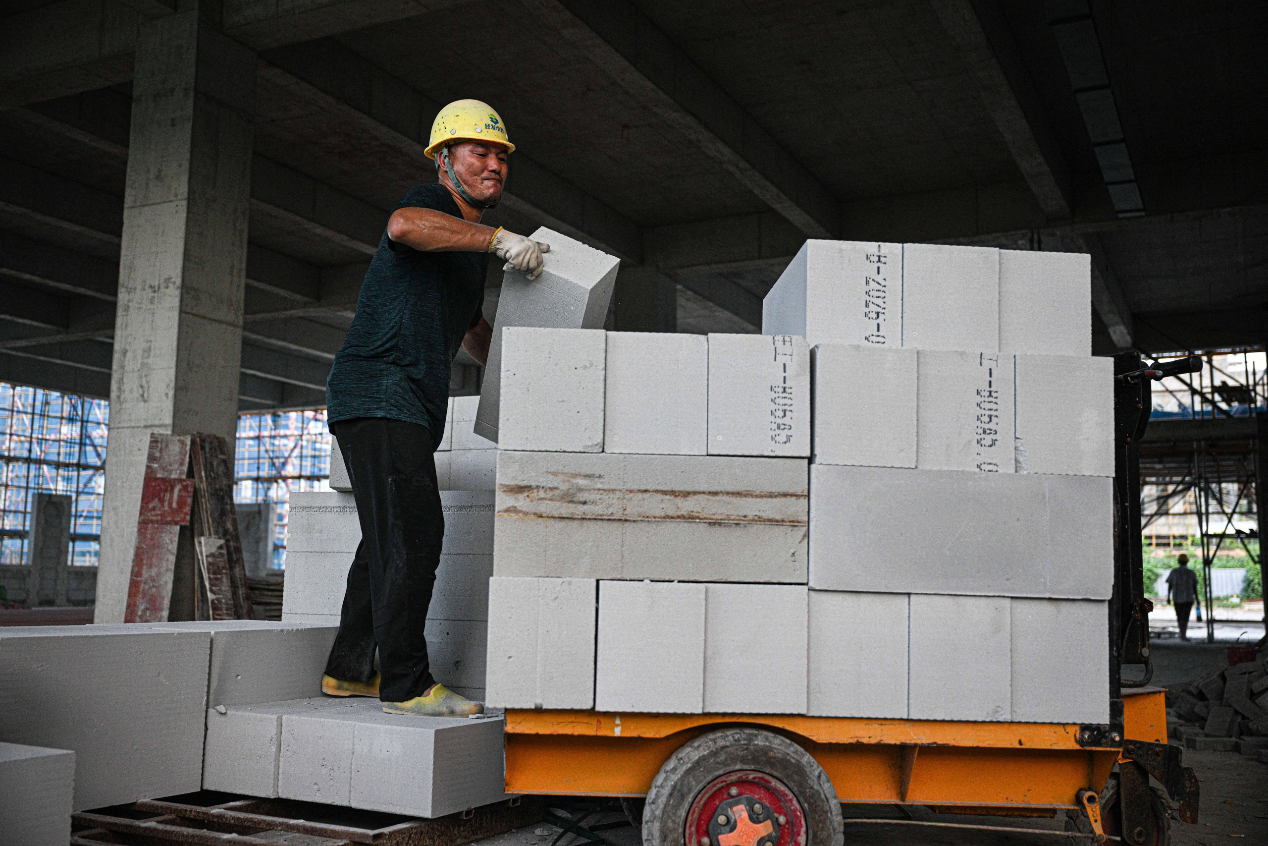 man loading cement blocks
