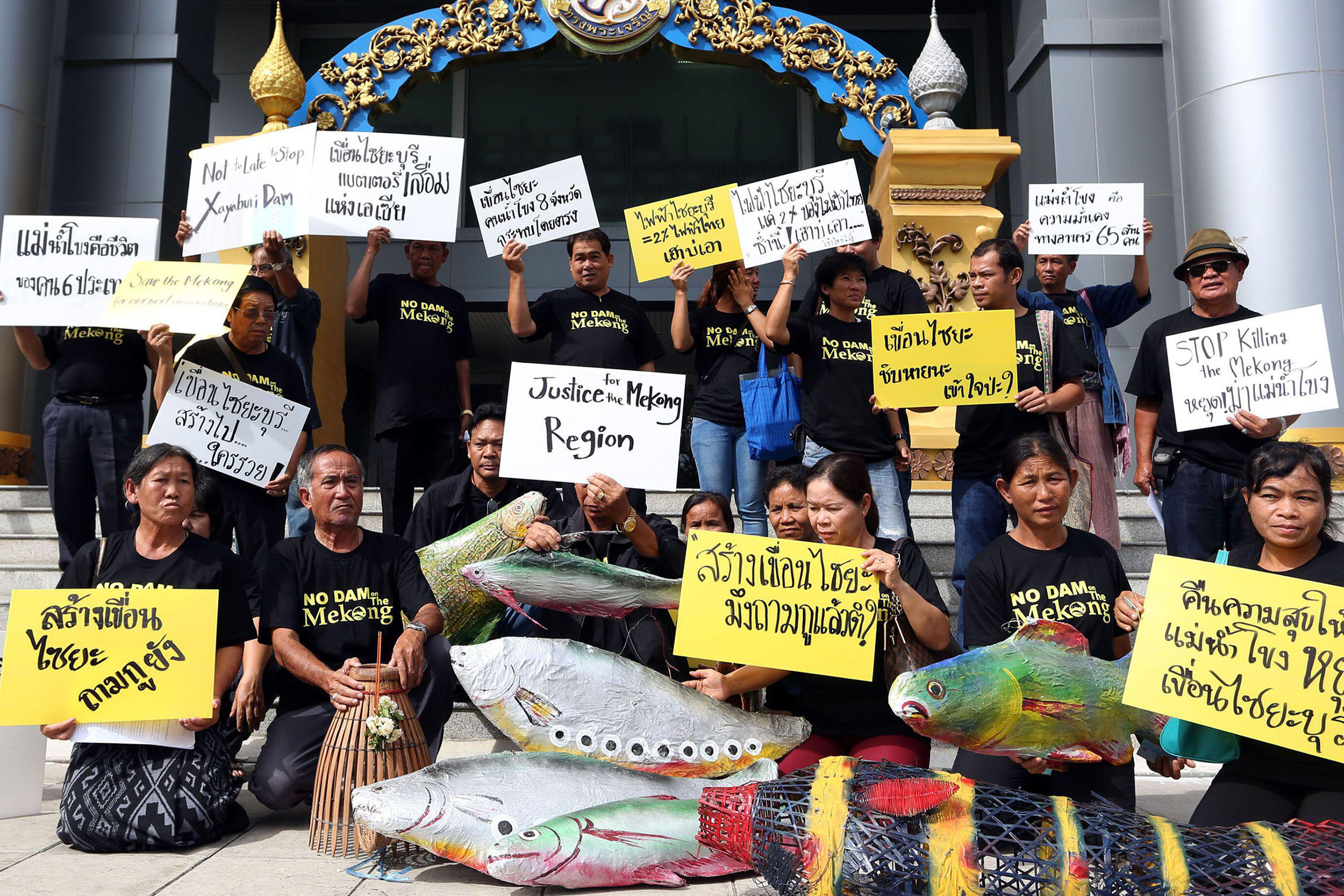 group of people posing with signs