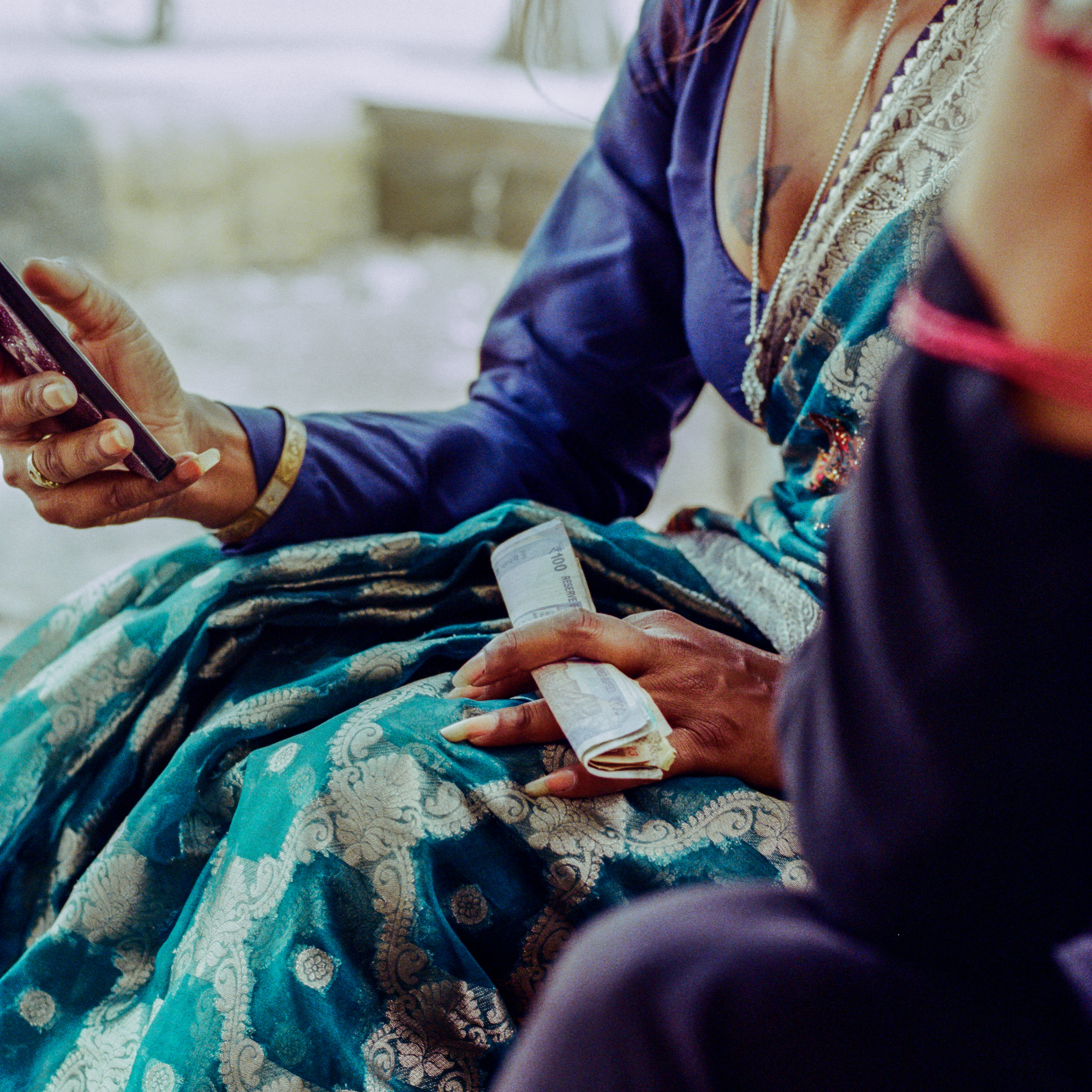 person holding phone and cash