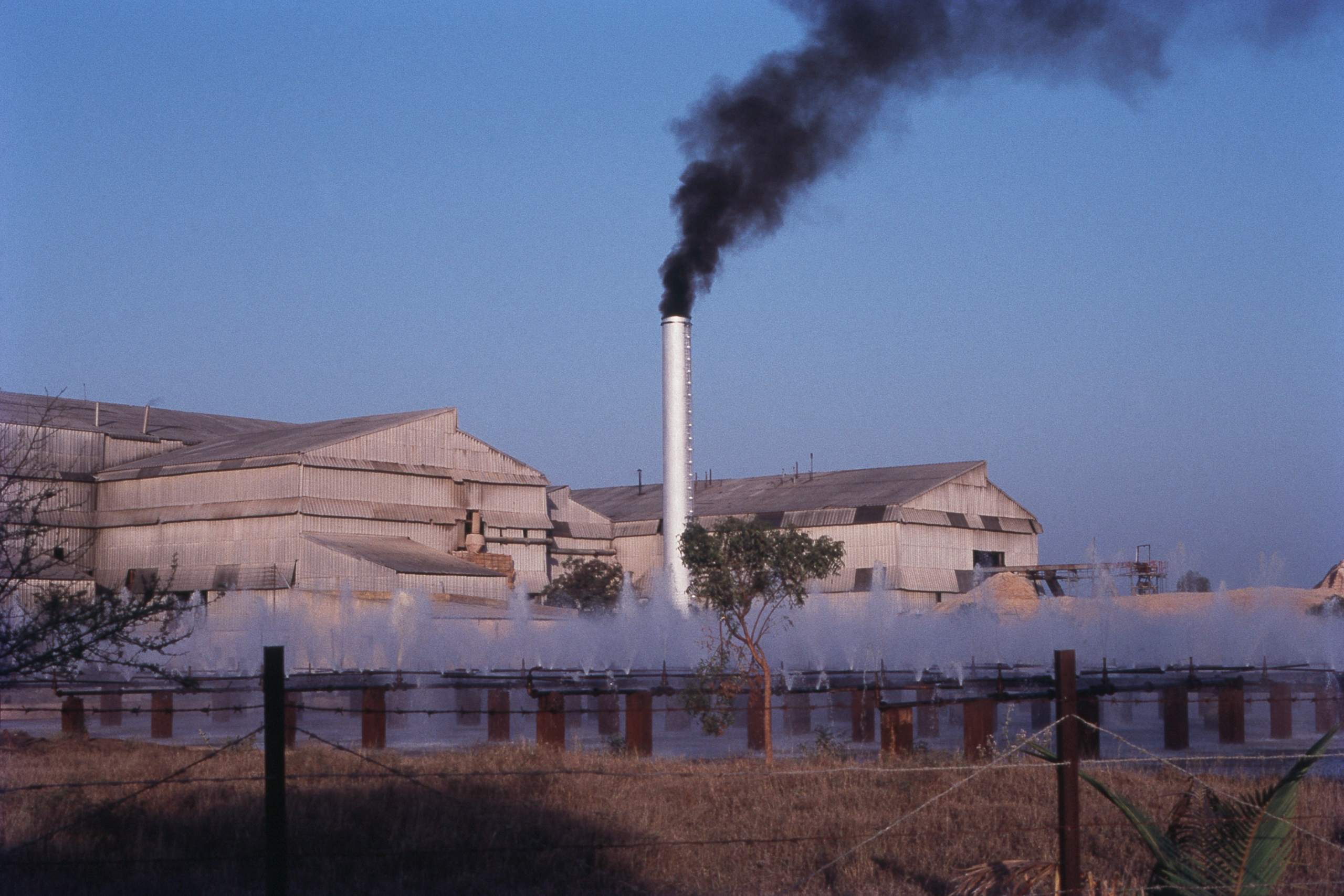 black smoke billowing from smokestack