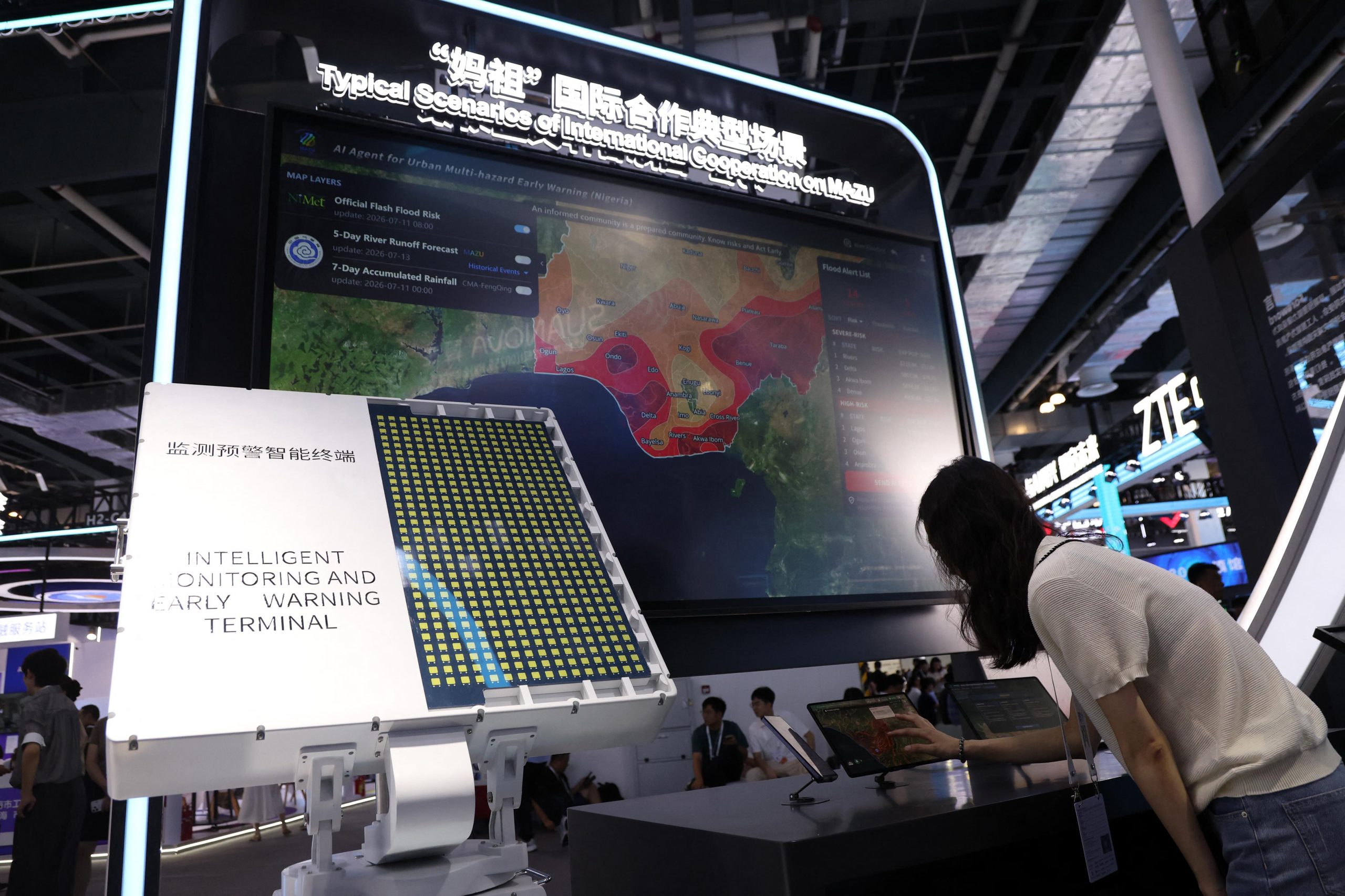 <p>An attendee interacts with Chinese AI system MAZU – short for “multi-hazard, alert, zero-gap and universal” – at the 2026 World Artificial Intelligence Conference in Shanghai, July 2026 (Image: Sipa US / Alamy)</p>