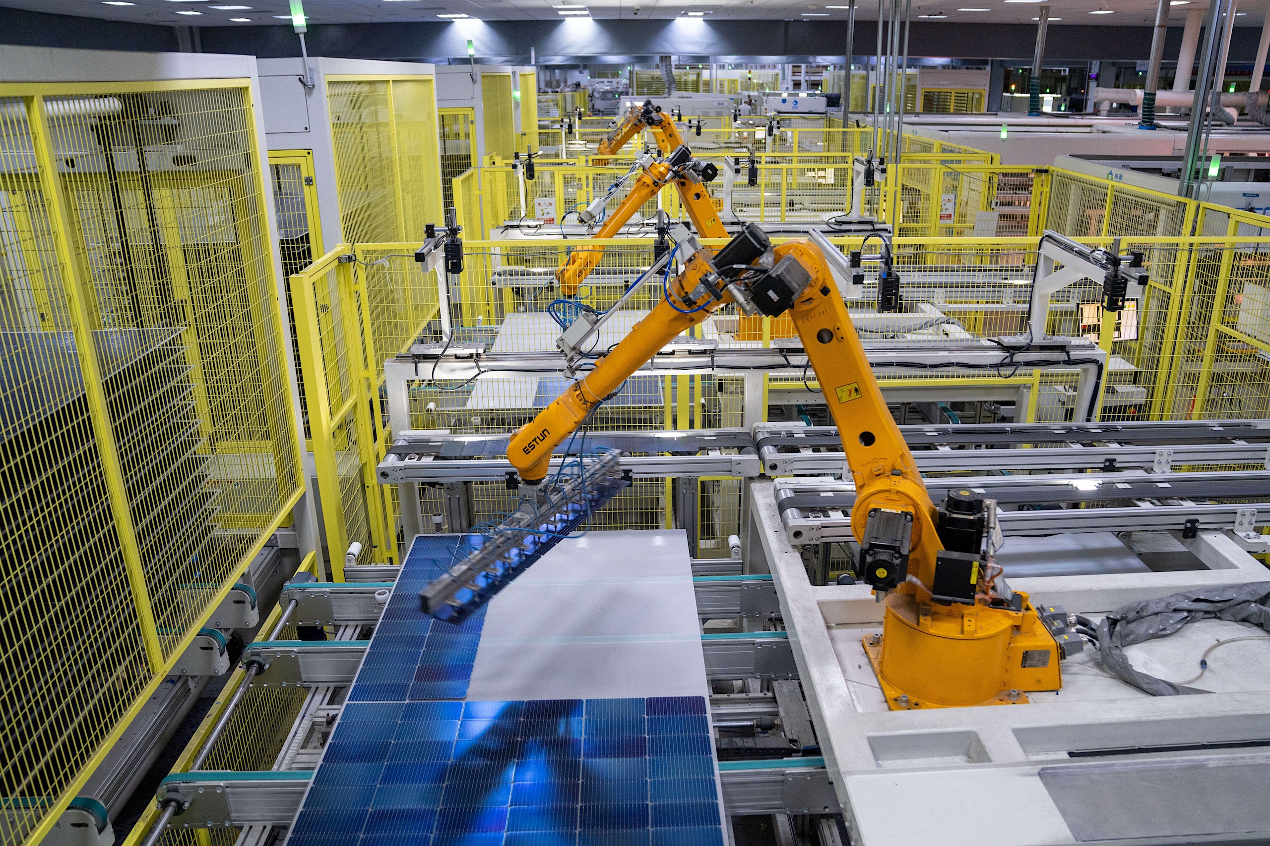 <p>A robot positions solar cells at a module production line in Hefei, Anhui province (Image: Cynthia Lee / Alamy)</p>