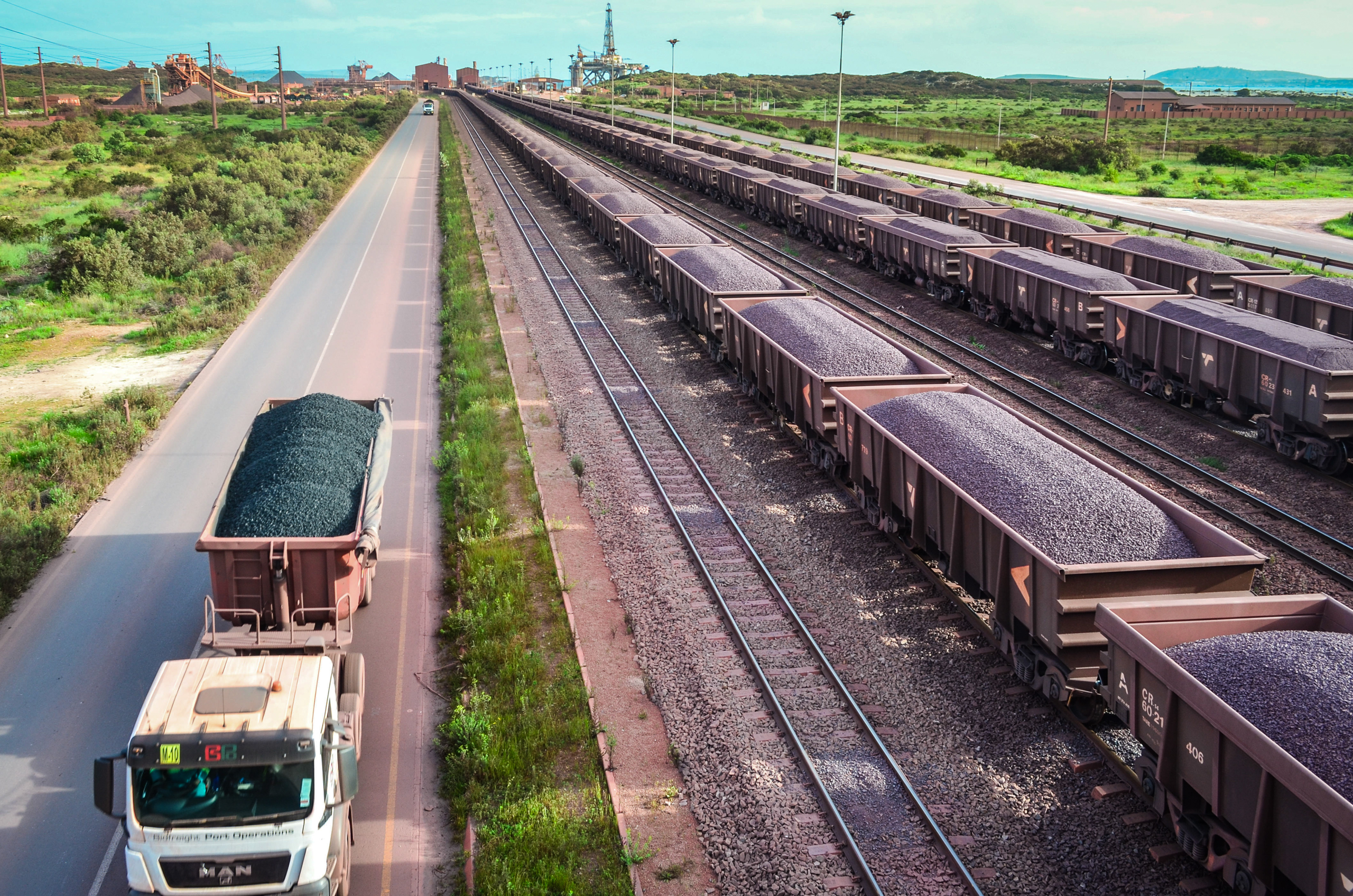 wagons and trucks carrying ore on parallel tracks