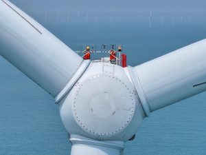 Workers conducting maintenance on a wind turbine at an offshore wind farm