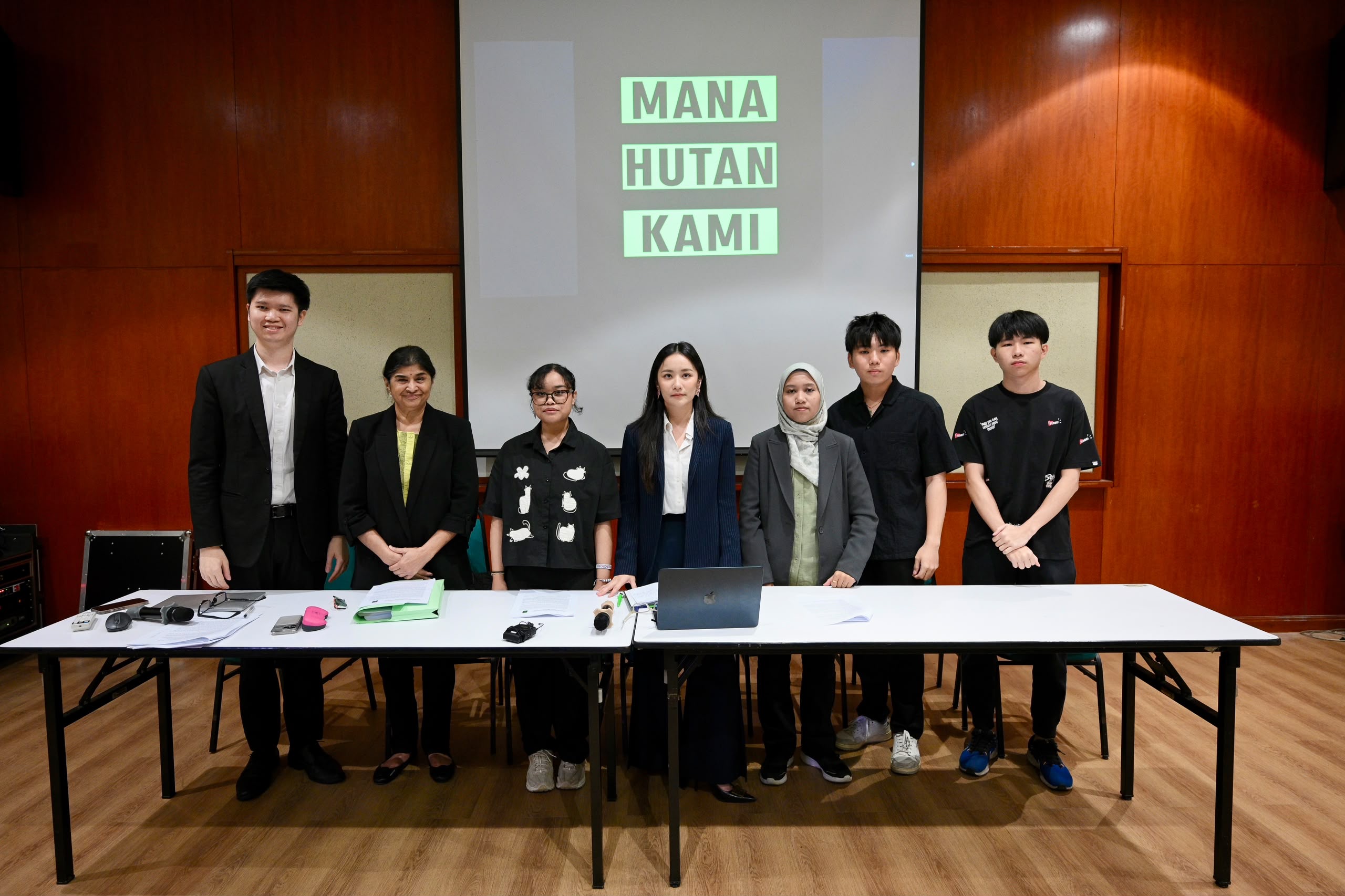 seven people standing behind conference table